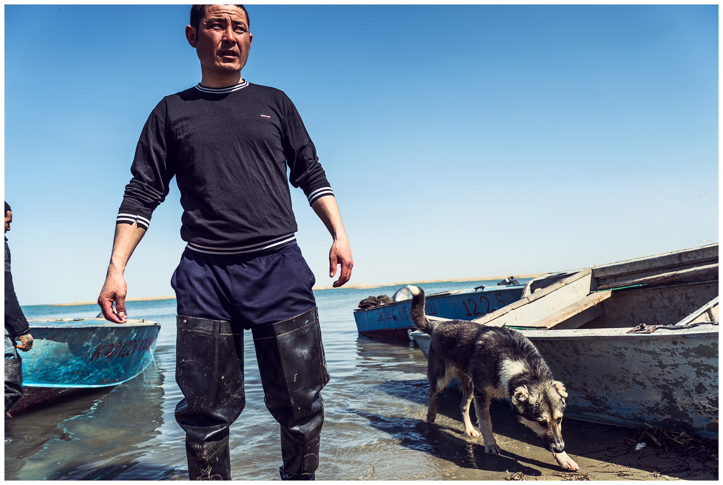 A fisherman comes home from work with his dog