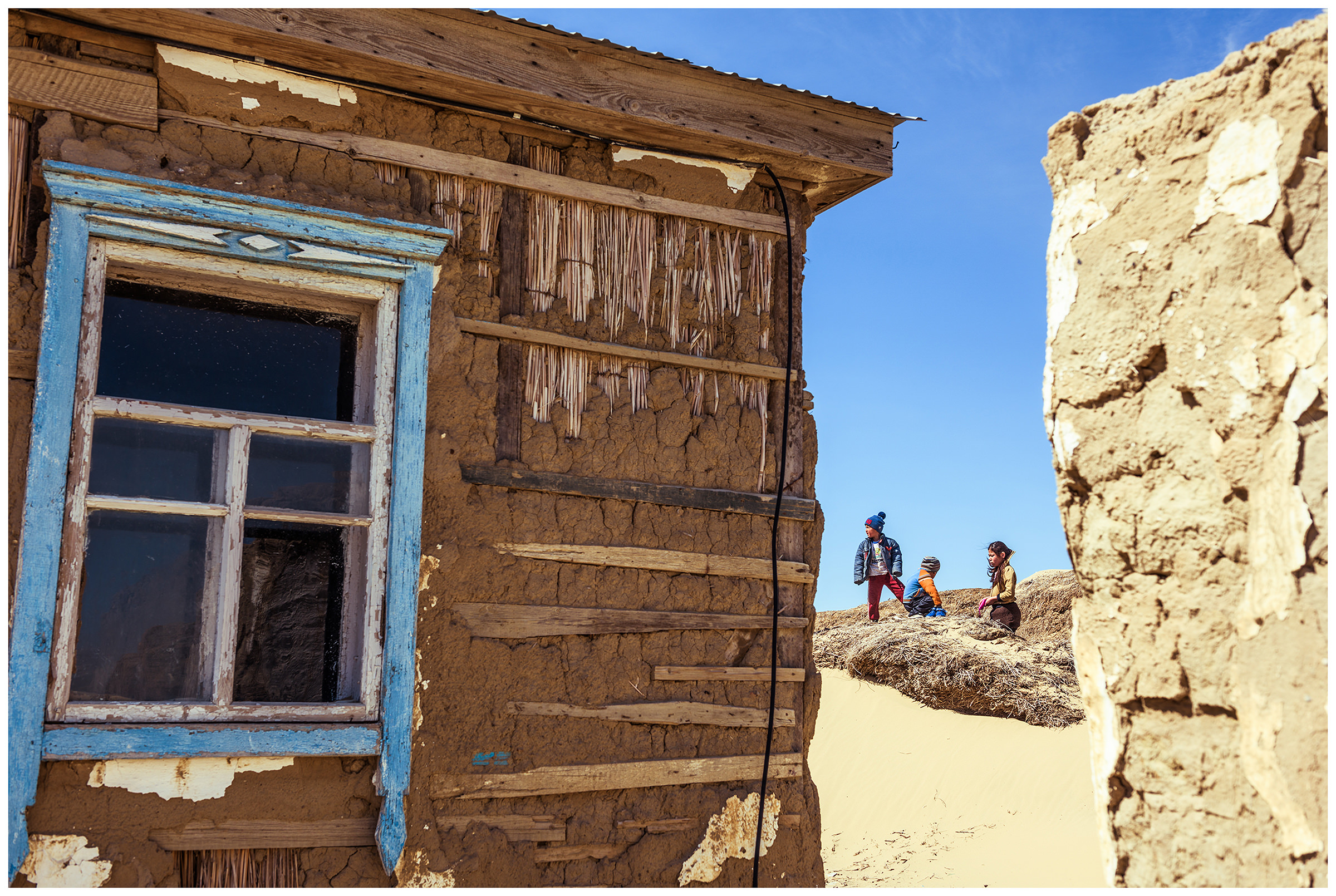 Children play in the sand in the fishing village of Akespe