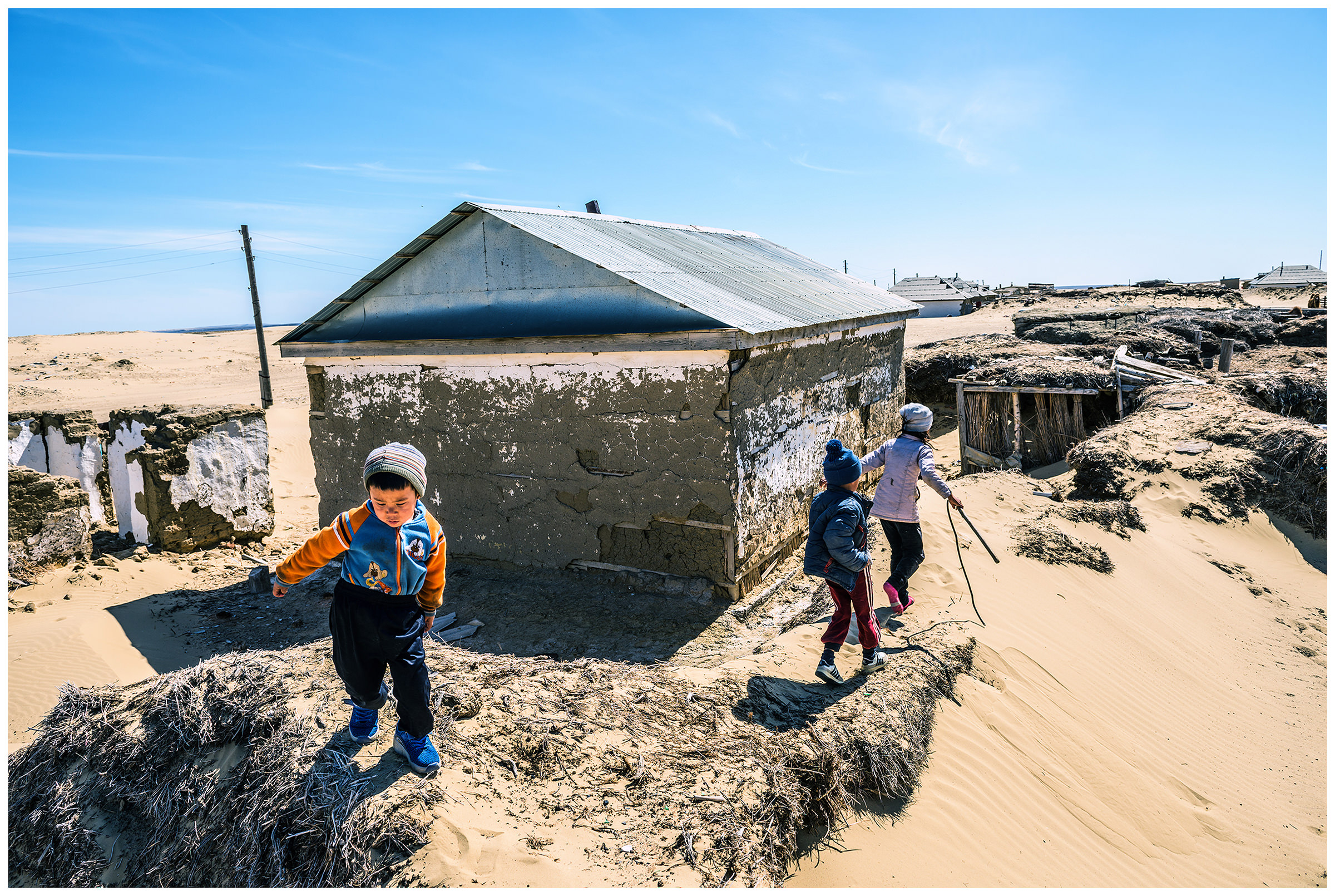 Children play in the sand in the fishing village of Akespe