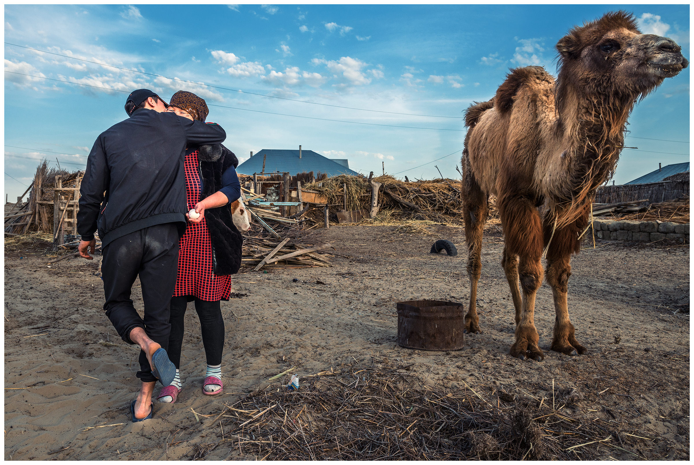 A young man embraces his mother in the fishing village Bogen