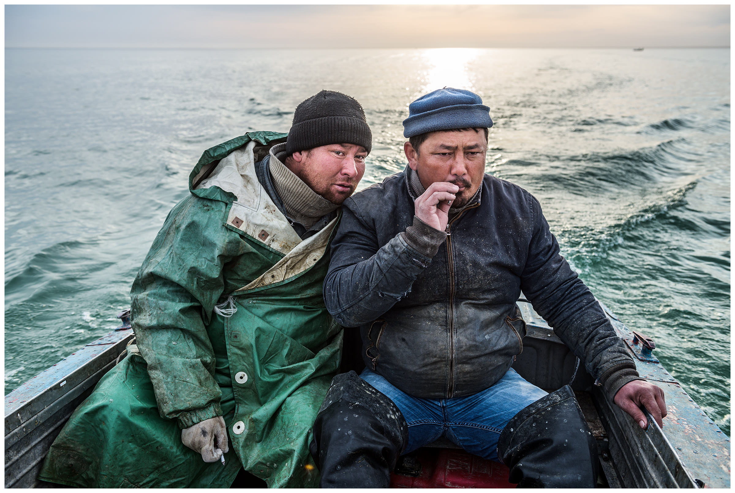 Two fishermen are sitting in their boat