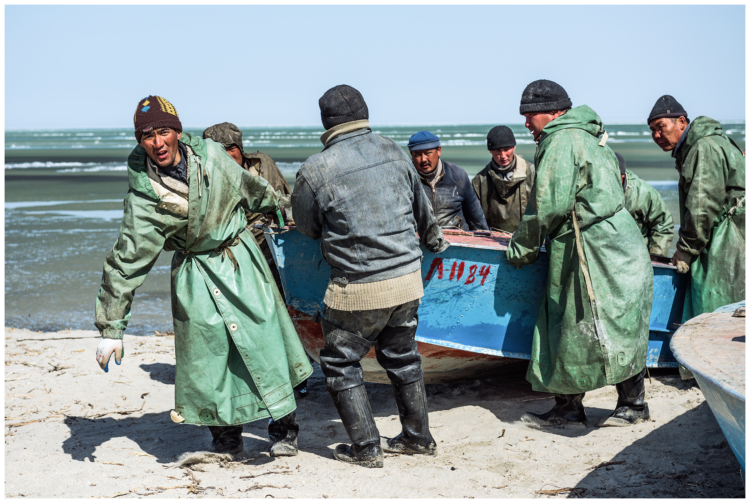 Fishermen bring their boats to the coast