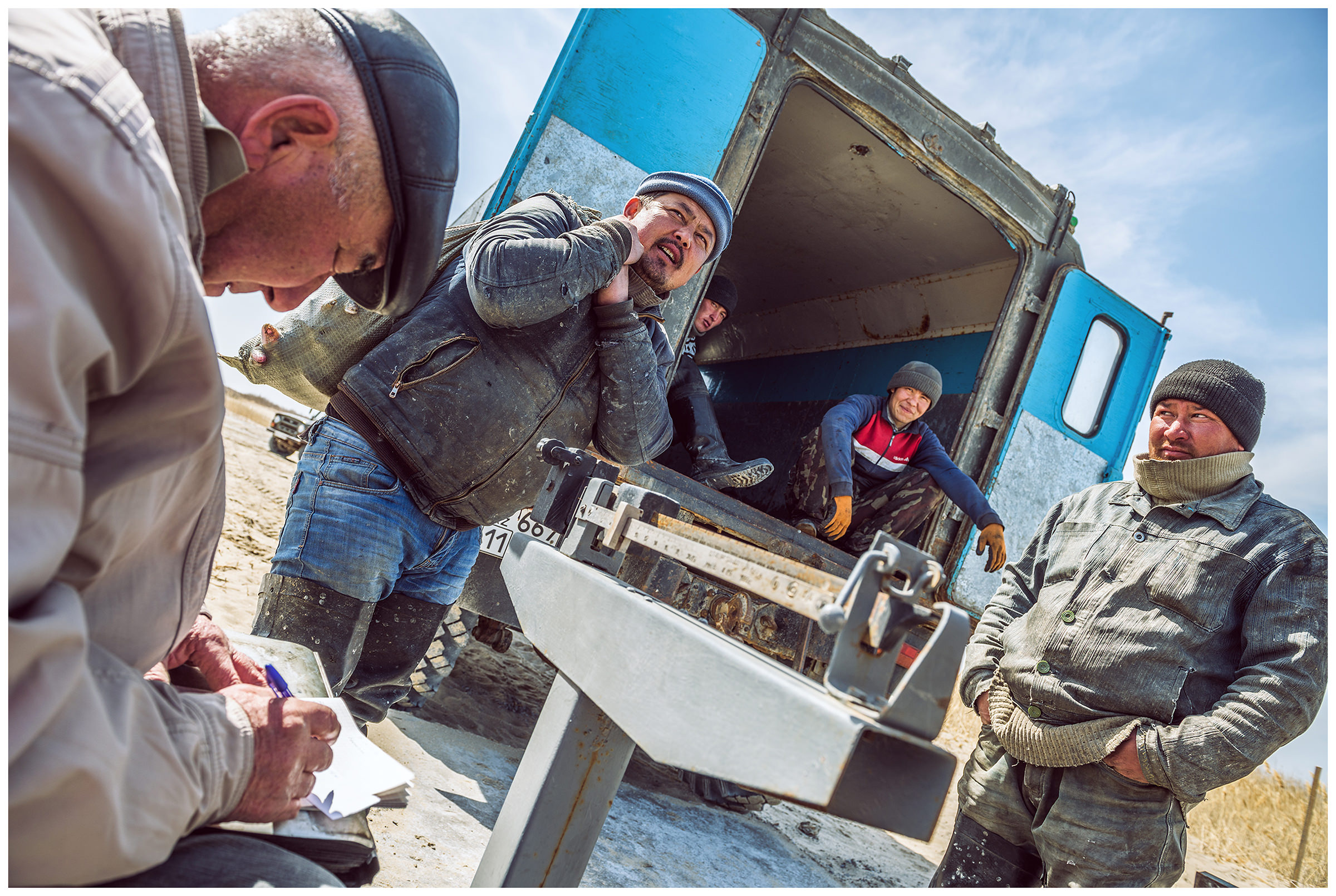 A fisherman weighs the catch