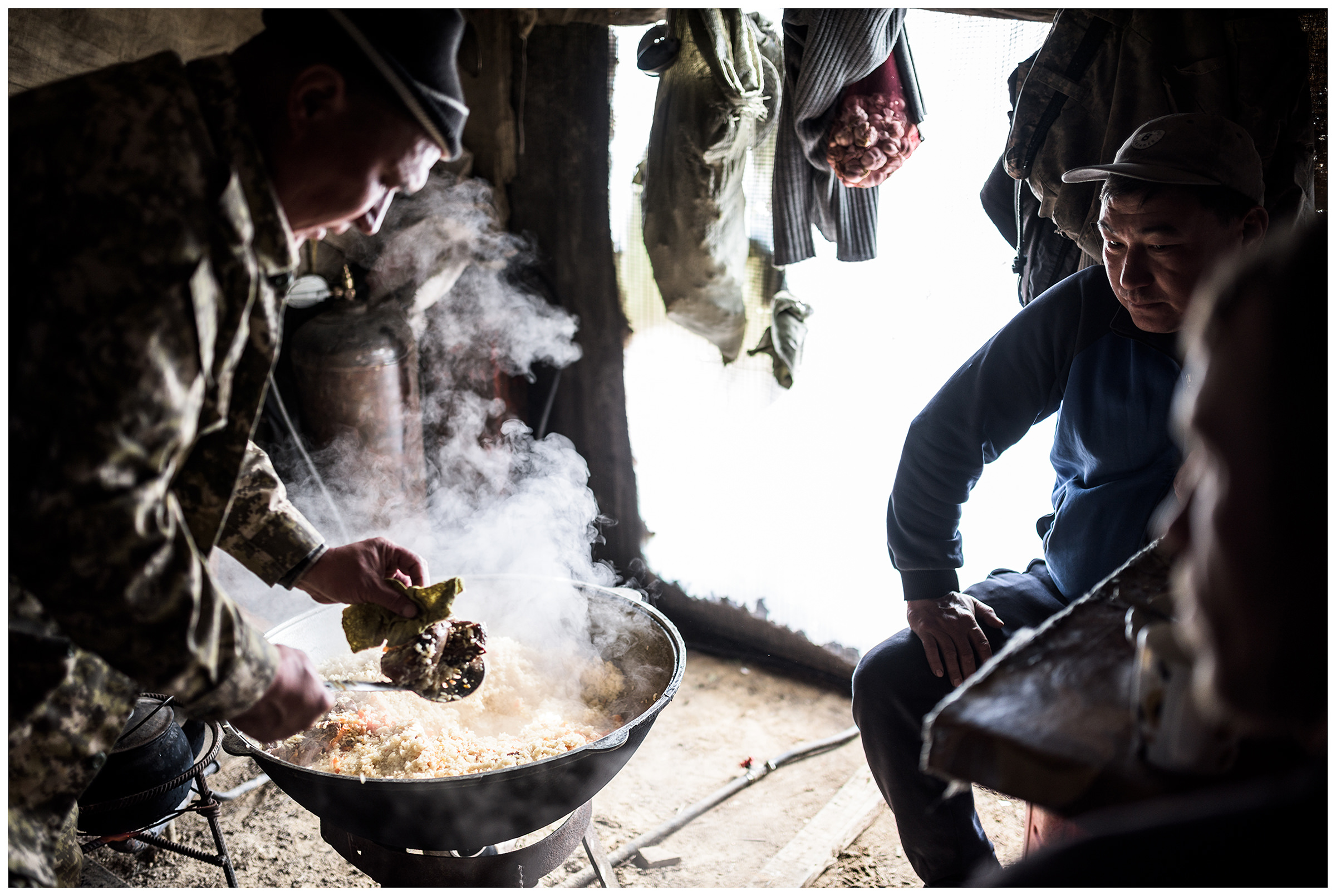 A fisherman takes care of the usbekian national dish Plow