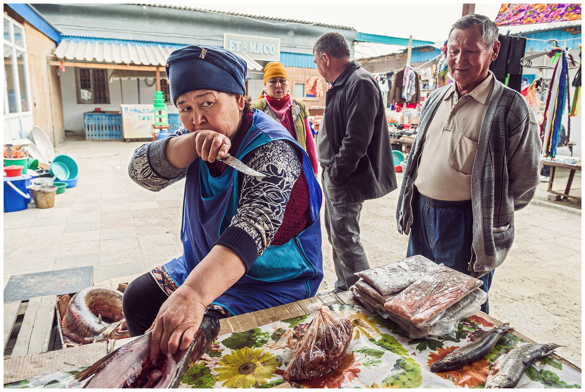 A fish seller takes out a fish at the fish market