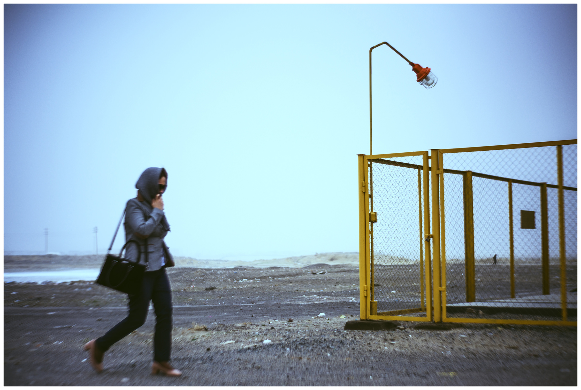 A woman walks on a road from Aral