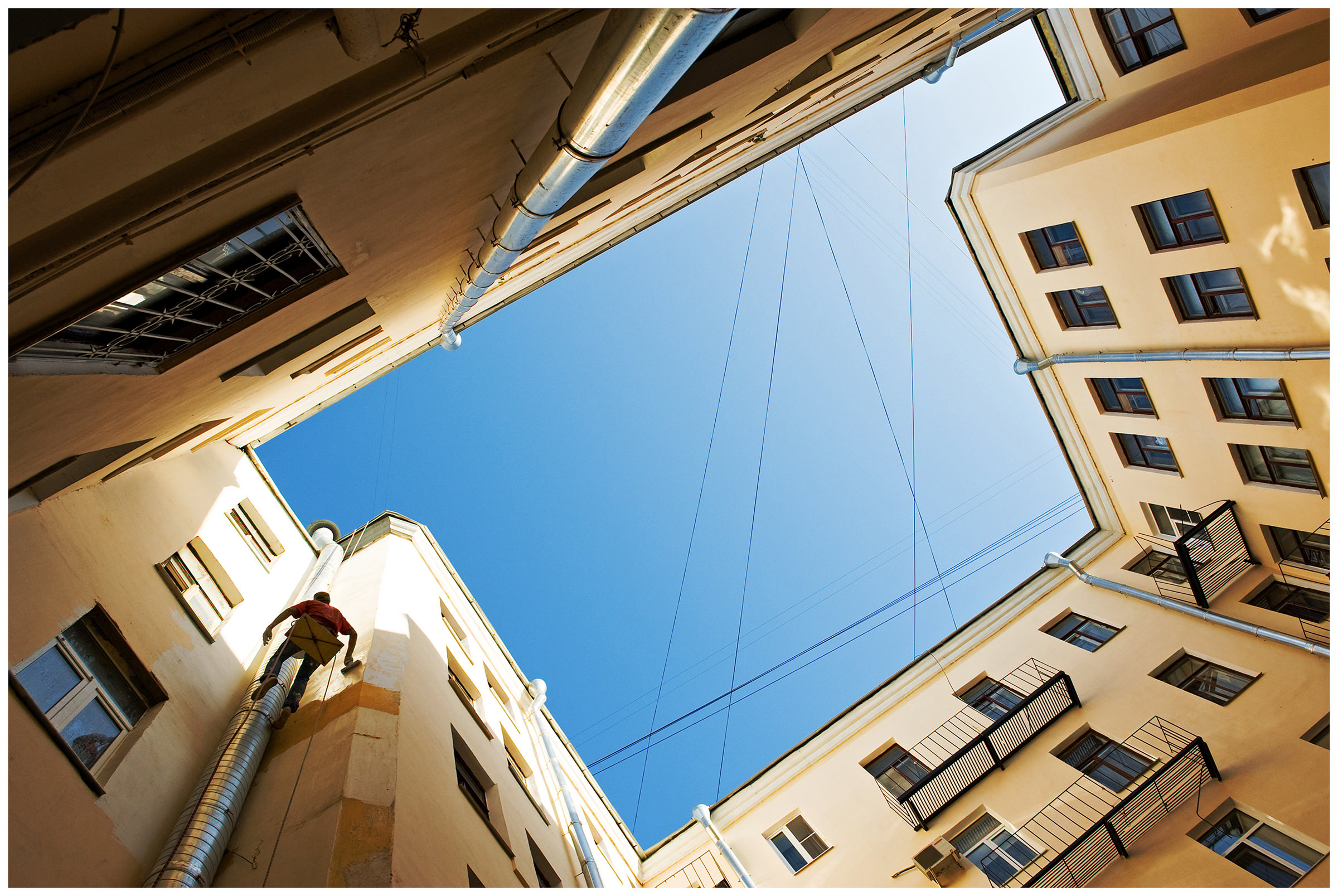 Saint Petersburg, Russia. A guest worker painting the walls of a house.