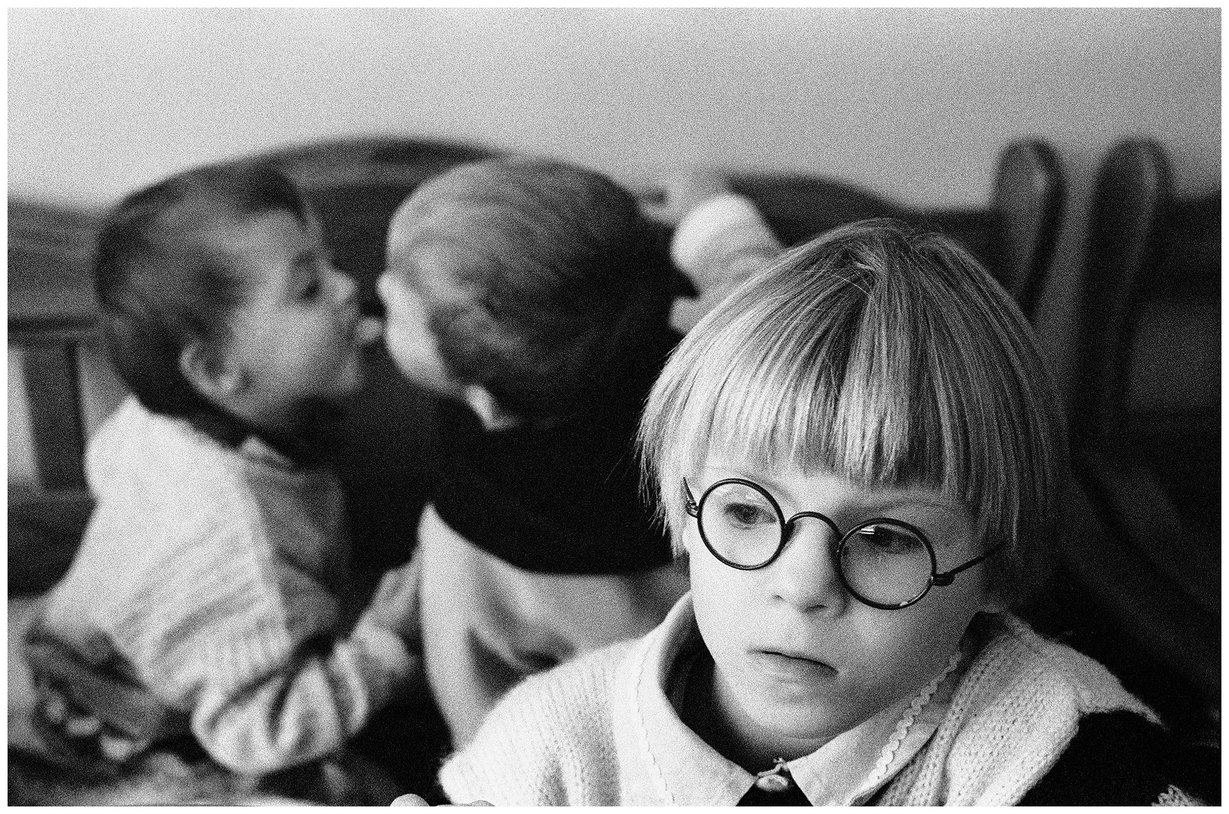 Minsk, Belarus. Two psychophysically handicapped boys kiss behind the back of a girl.