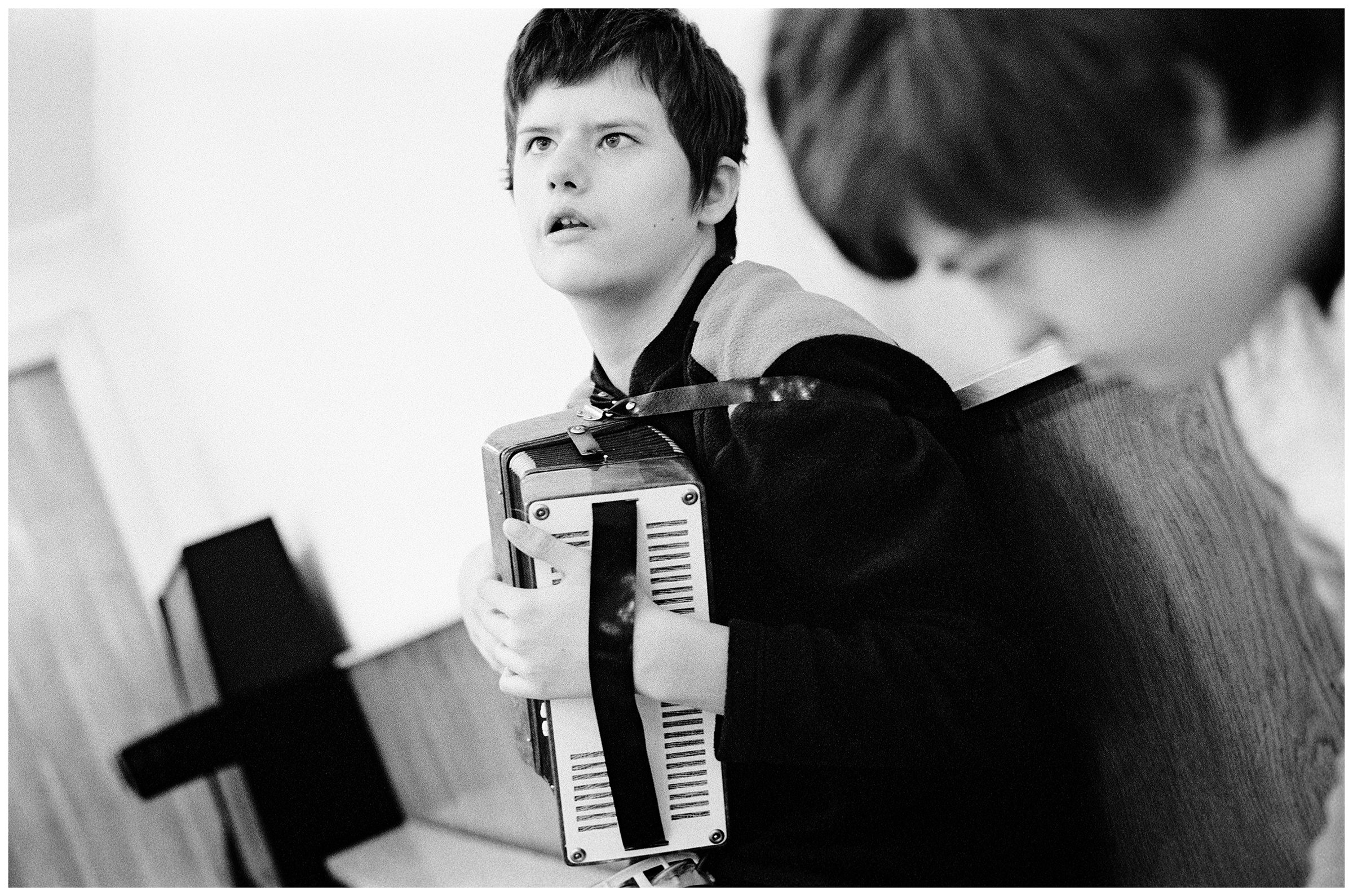 Minsk, Belarus. A psychophysically handicapped boy plays accordion.