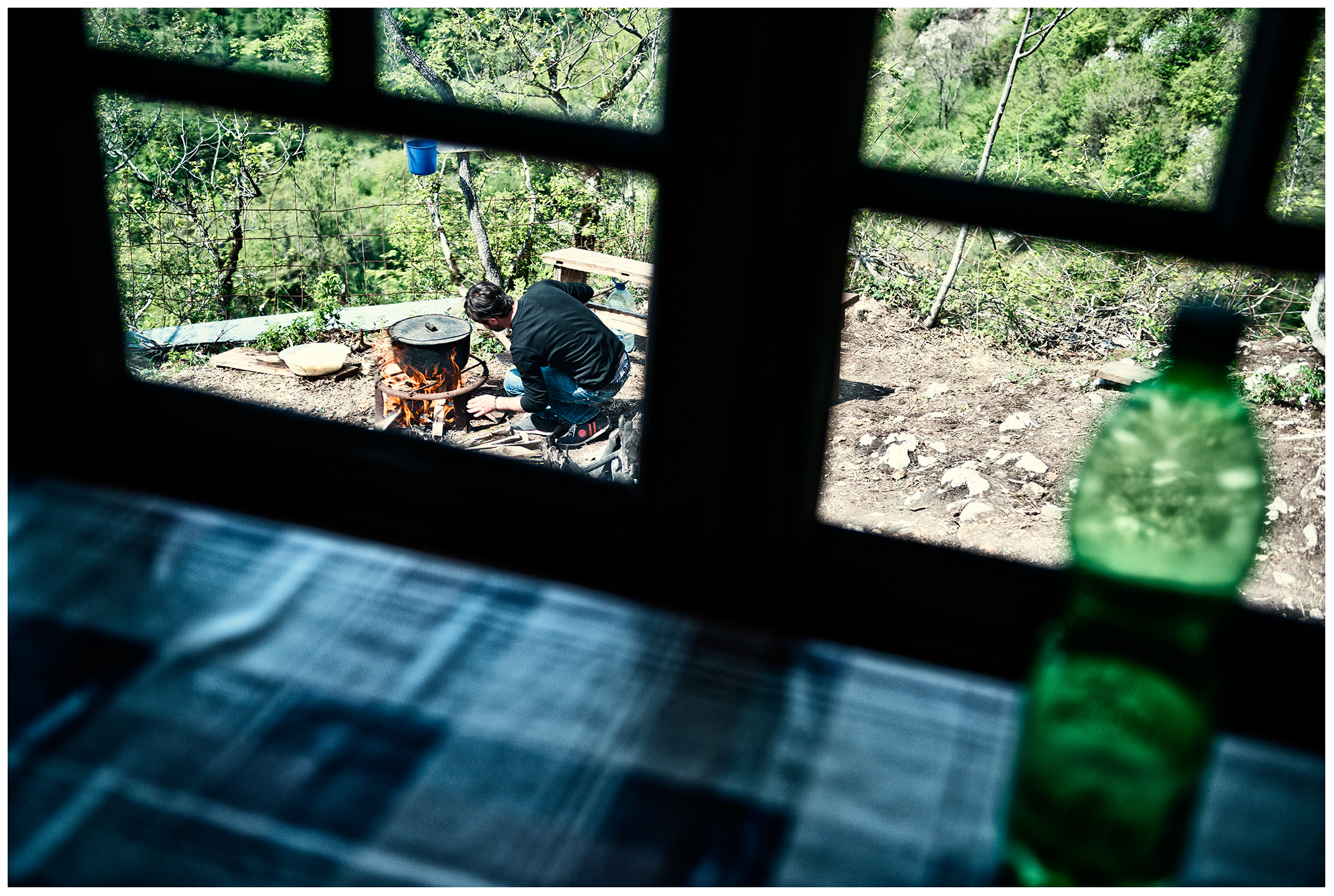Imereti, Georgia. A friend of the Georgian monk Maxime Kavtaradze cooks on a campfire on a rock.