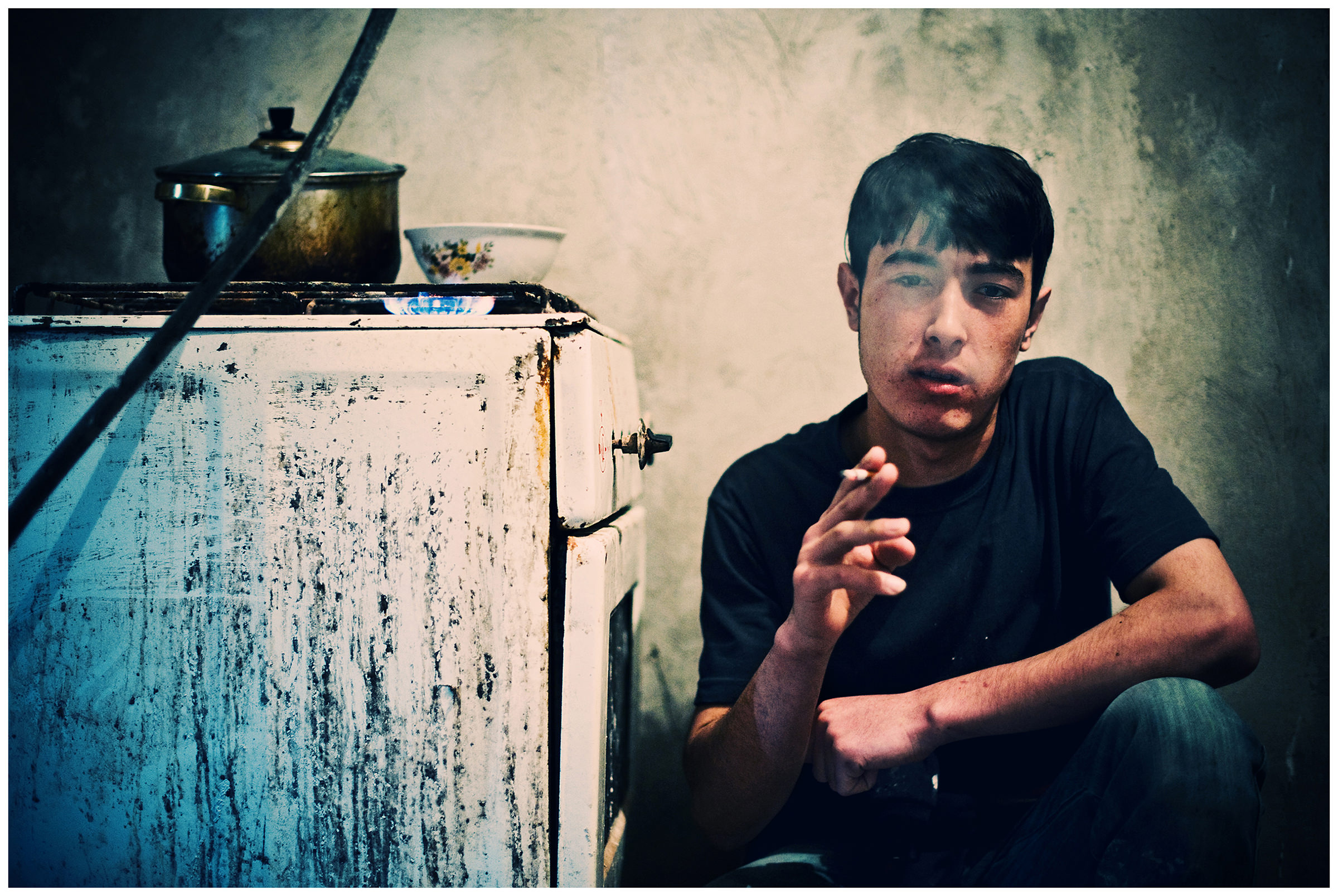 Saint Petersburg, Russia. An Uzbek guest worker smokes at a construction site.