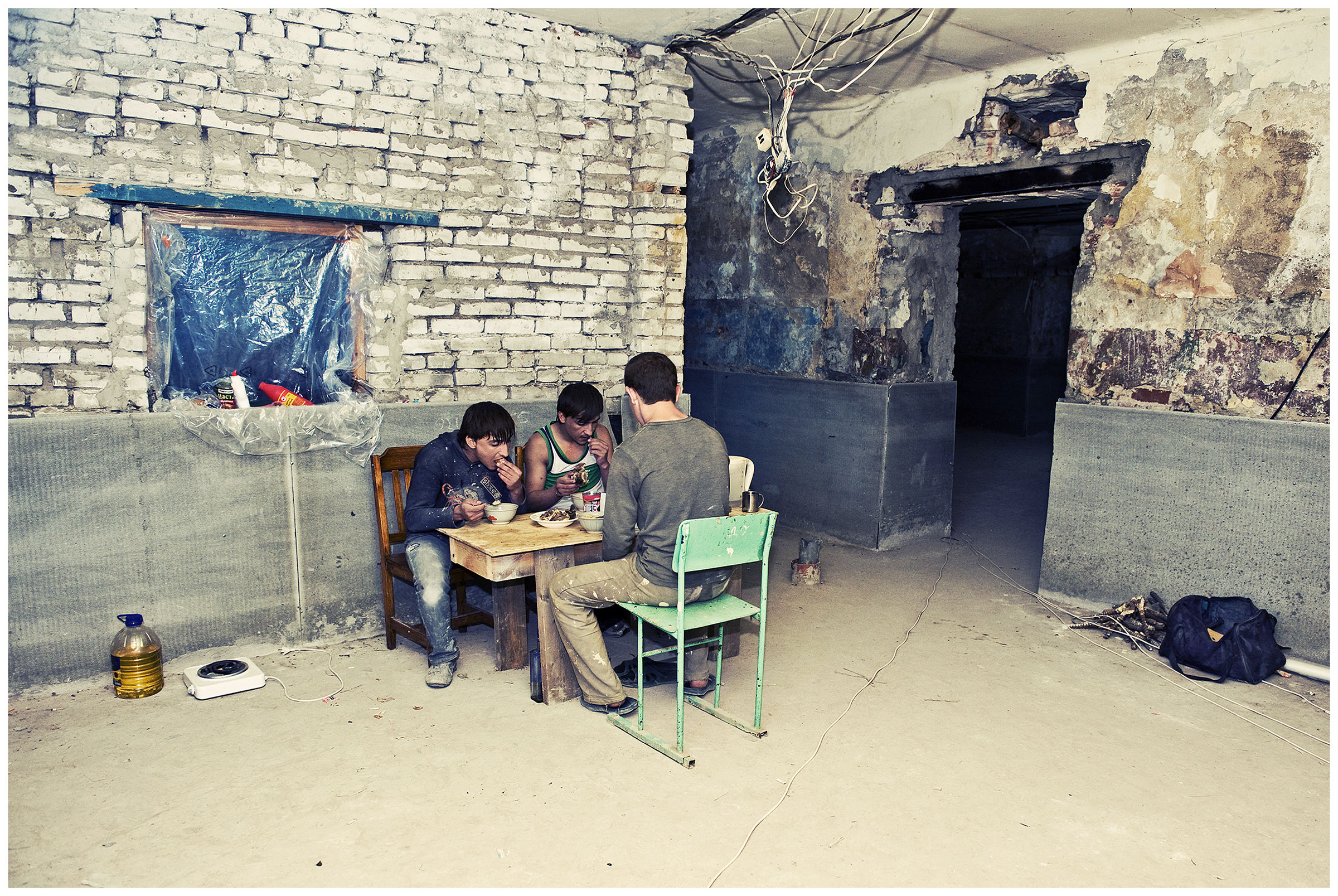 Vyborg, Russia. The guest workers from Georgia eat in a cellar which they use as their rented flat.