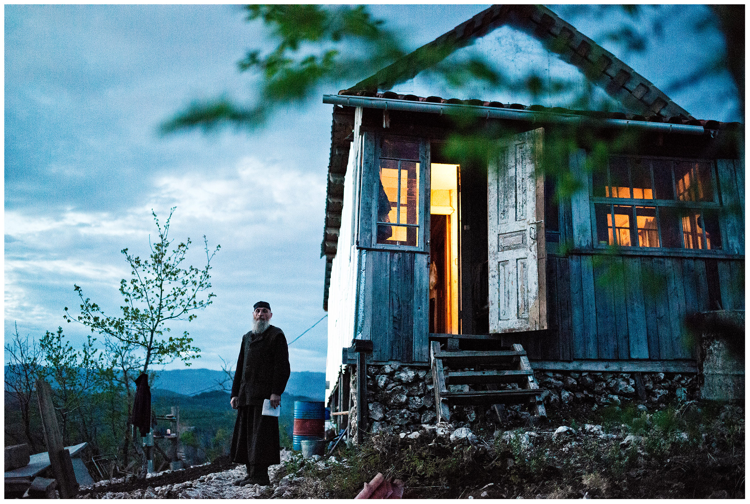 Imereti, Georgia. The Georgian monk Maxime Kavtaradze stands on a rock in front of his house.