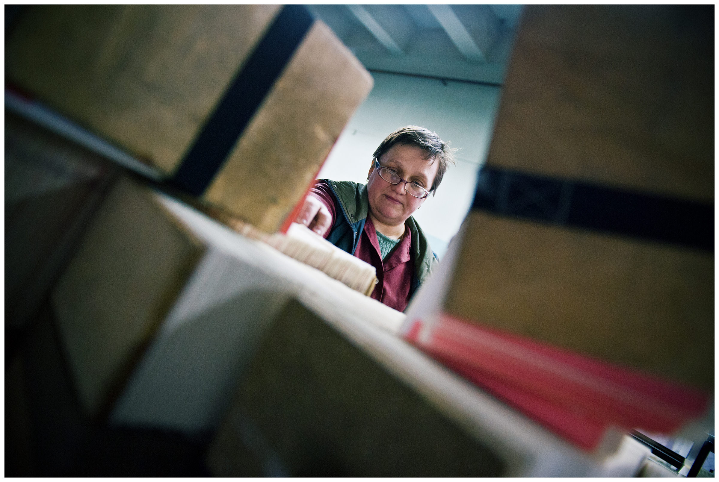 Minsk, Belarus, the publishing house "Pechatny Combinat". A worker sorts the pages of a book.