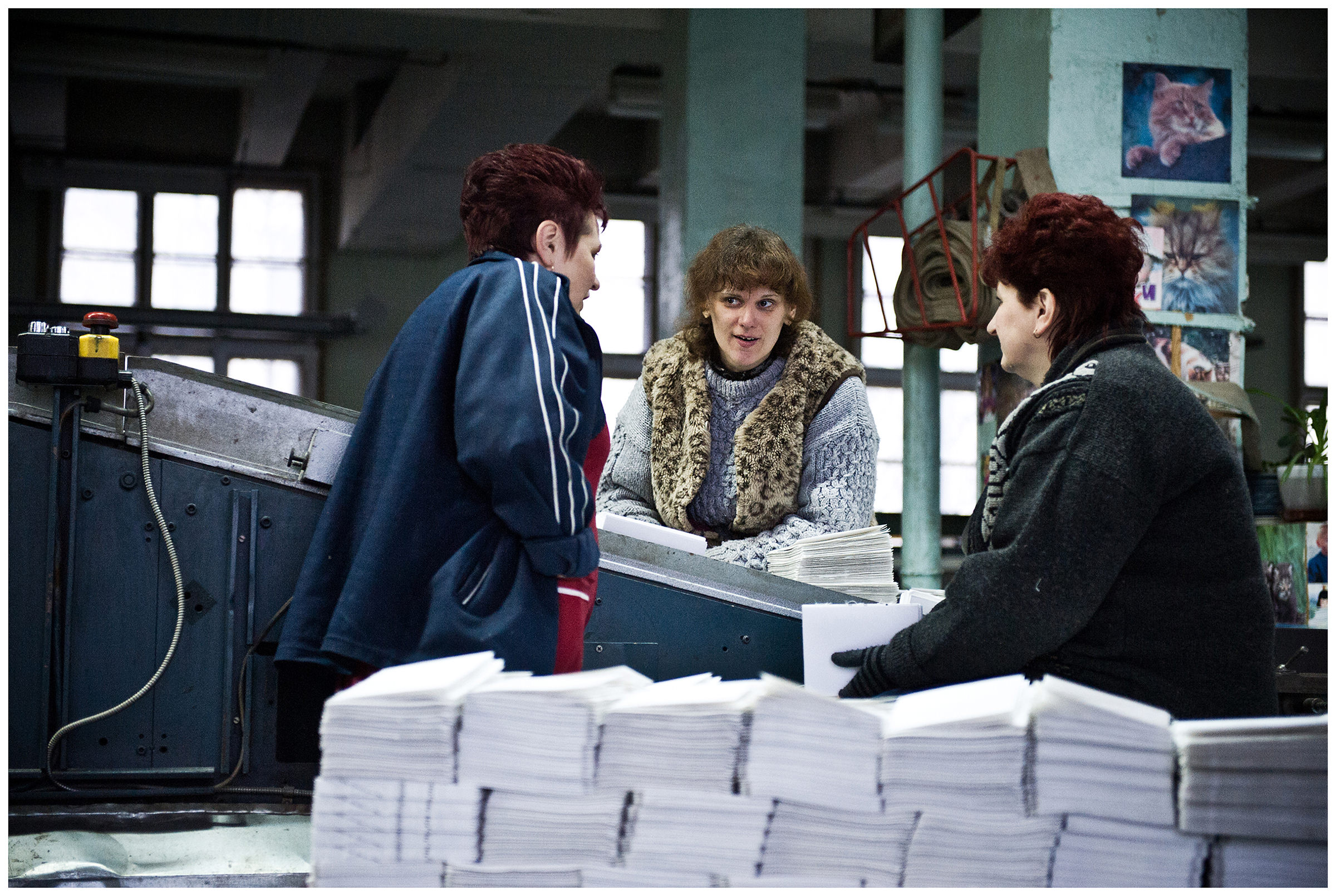 Minsk, Belarus, the publishing house "Pechatny Combinat". Three women workers chat at their workplace.