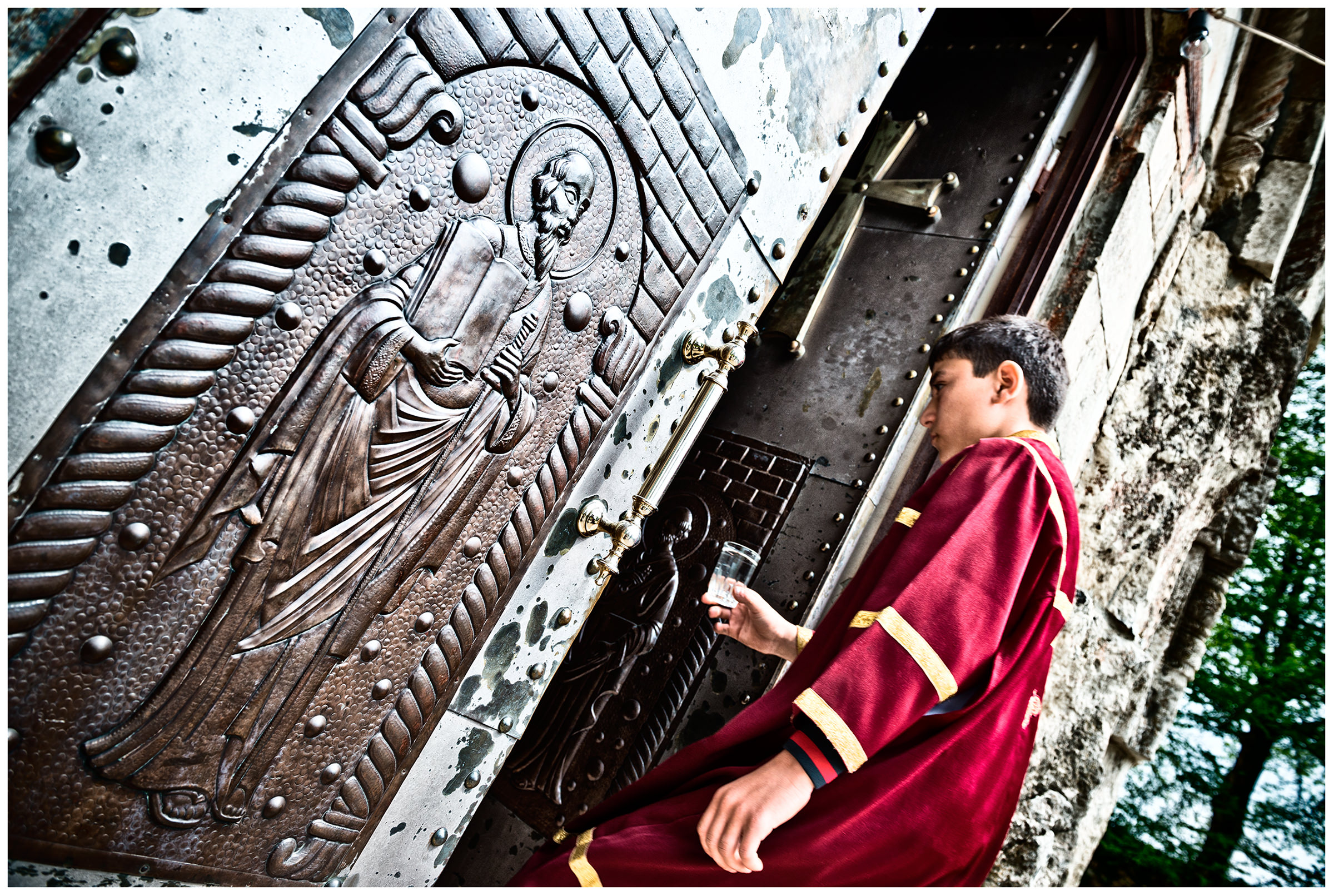 Imereti, Georgia. A boy in ecclesiastical garb goes to a monastery.