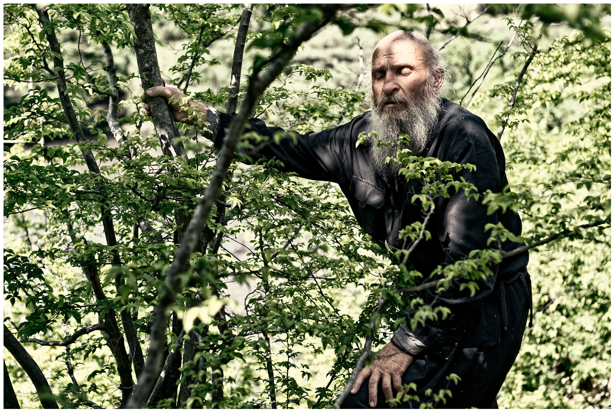 Imereti, Georgia. The Georgian monk Maxime Kavtaradze stands on a rock.