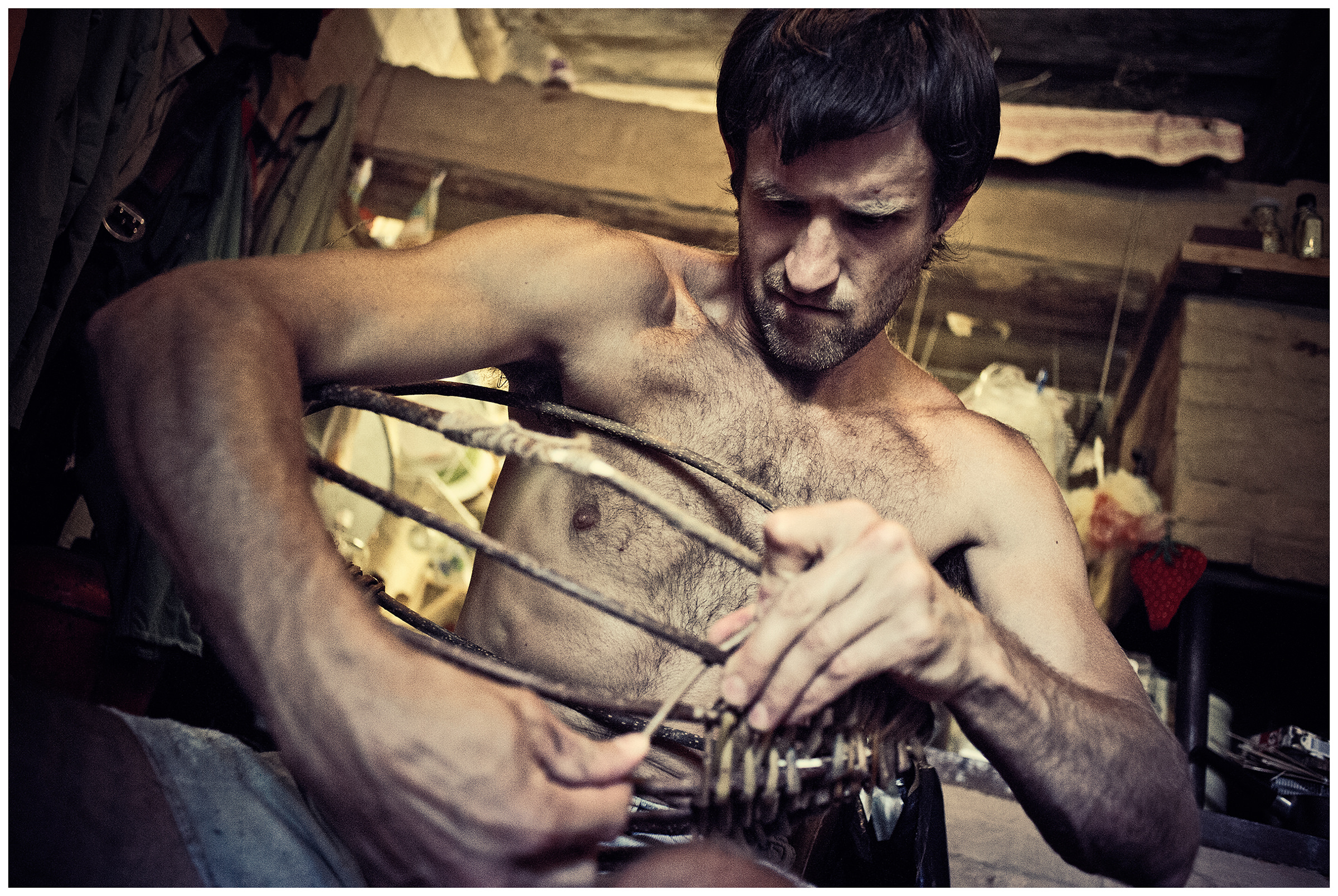 Belarus, village of Chereshlya. A man weaves a basket.