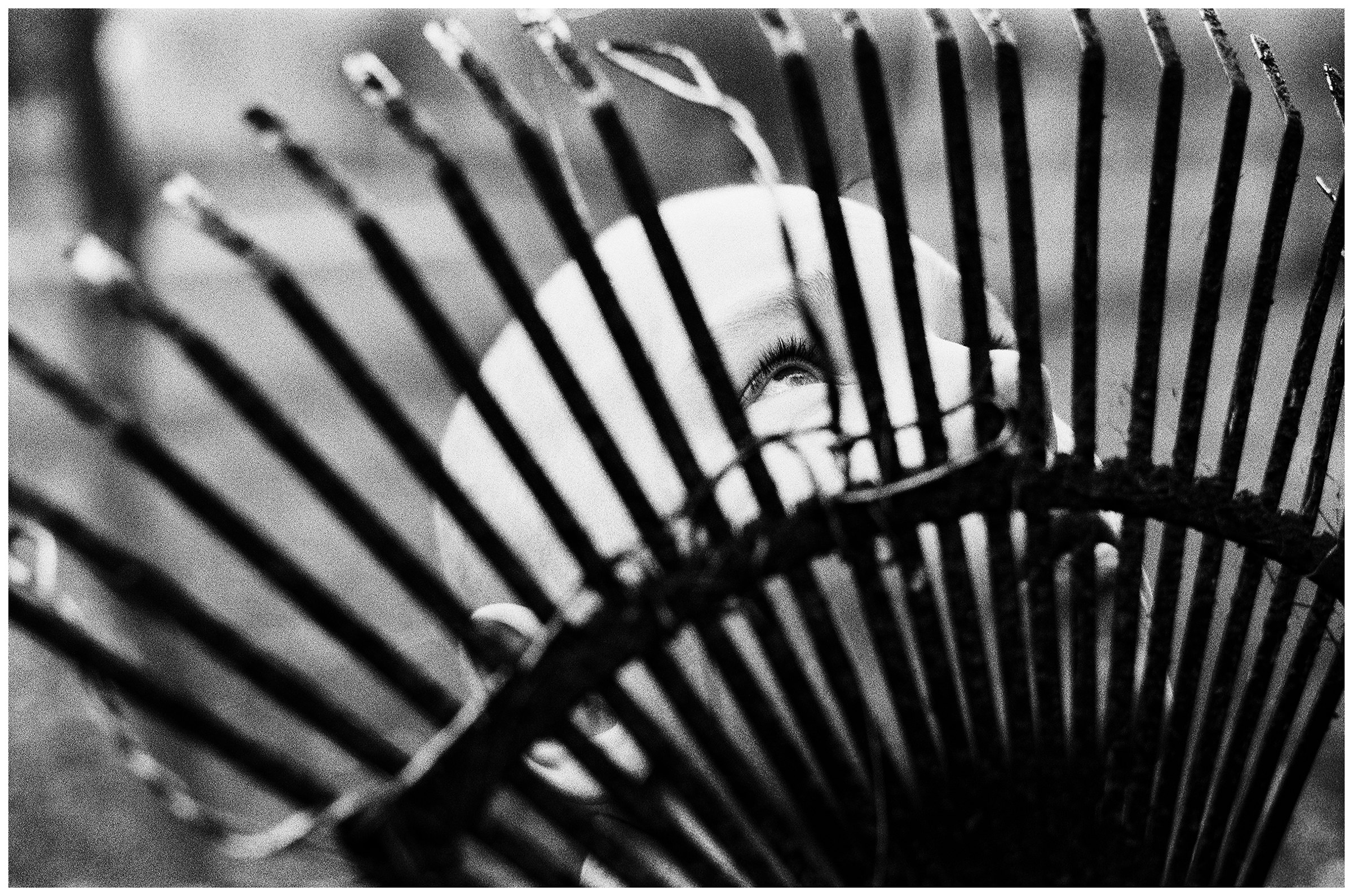 Minsk, Belarus. A boy stands behind a rake.