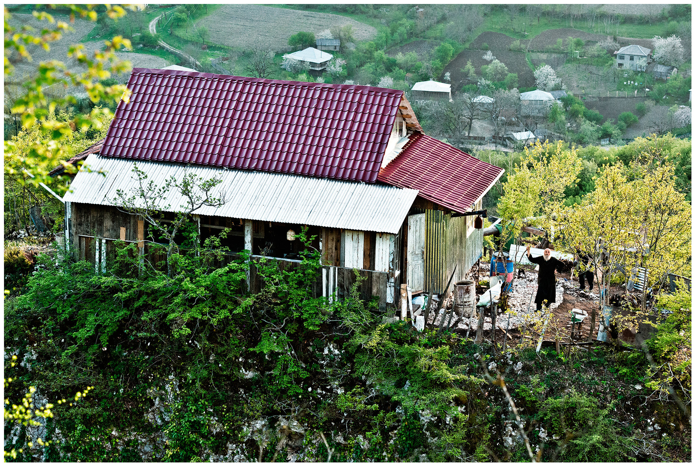 Imereti, Georgia. The Georgian monk Maxime Kavtaradze stands on a rock in front of his house.