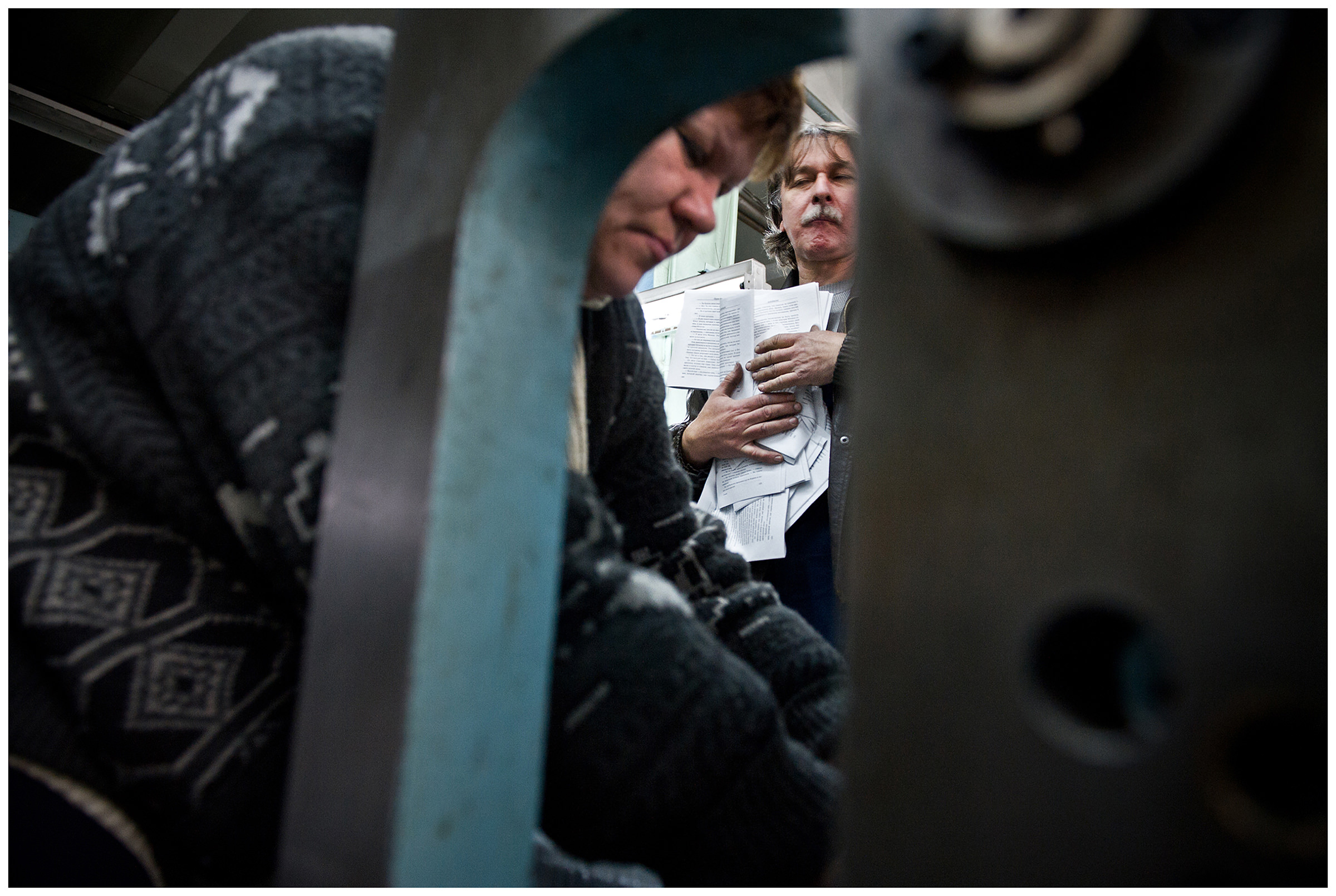 Minsk, Belarus, the publishing house "Pechatny Combinat". A printer observes his colleague sorting the print production.