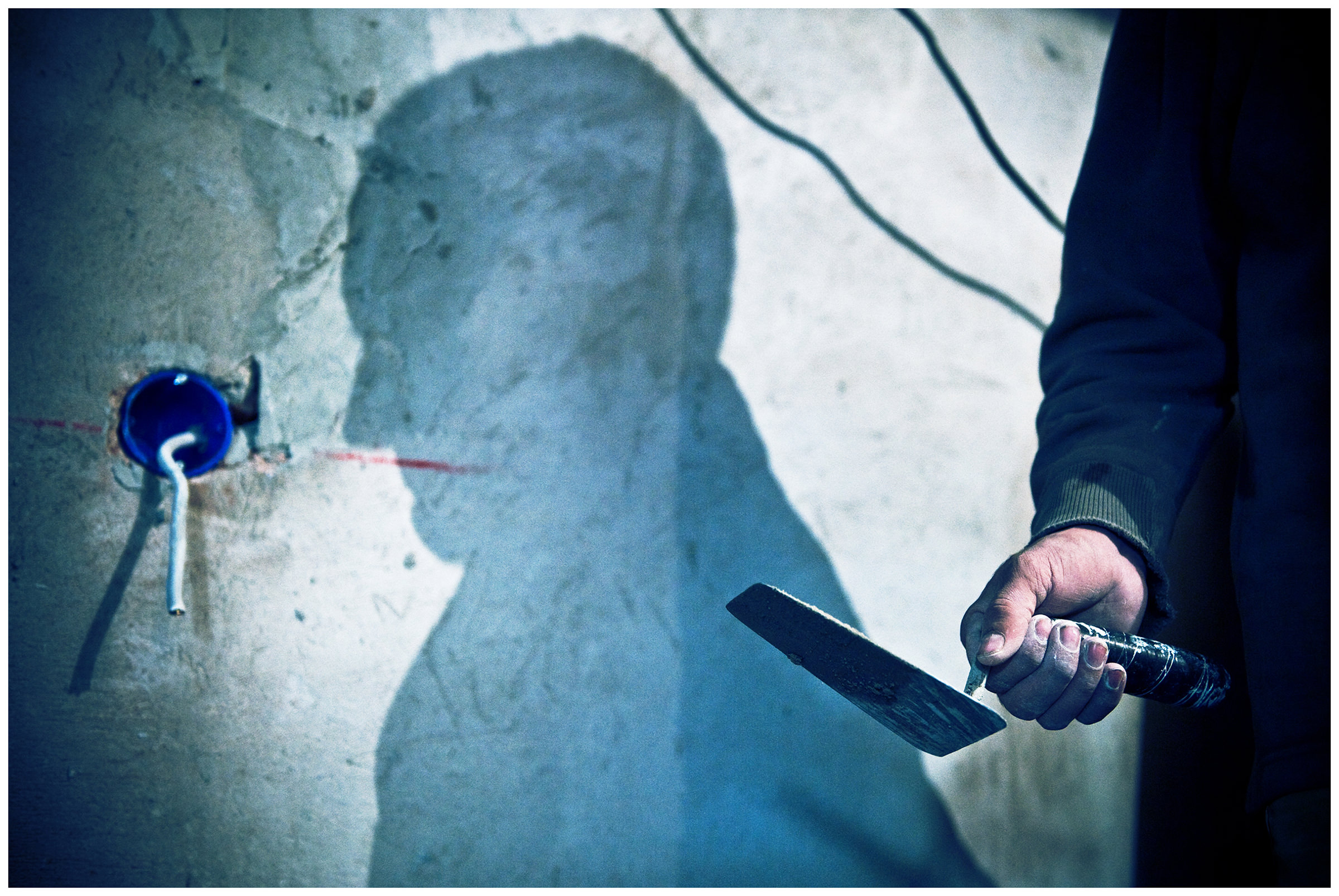 Saint Petersburg, Russia. An Uzbek guest worker is holding a motel ladle in his hand at a construction site.