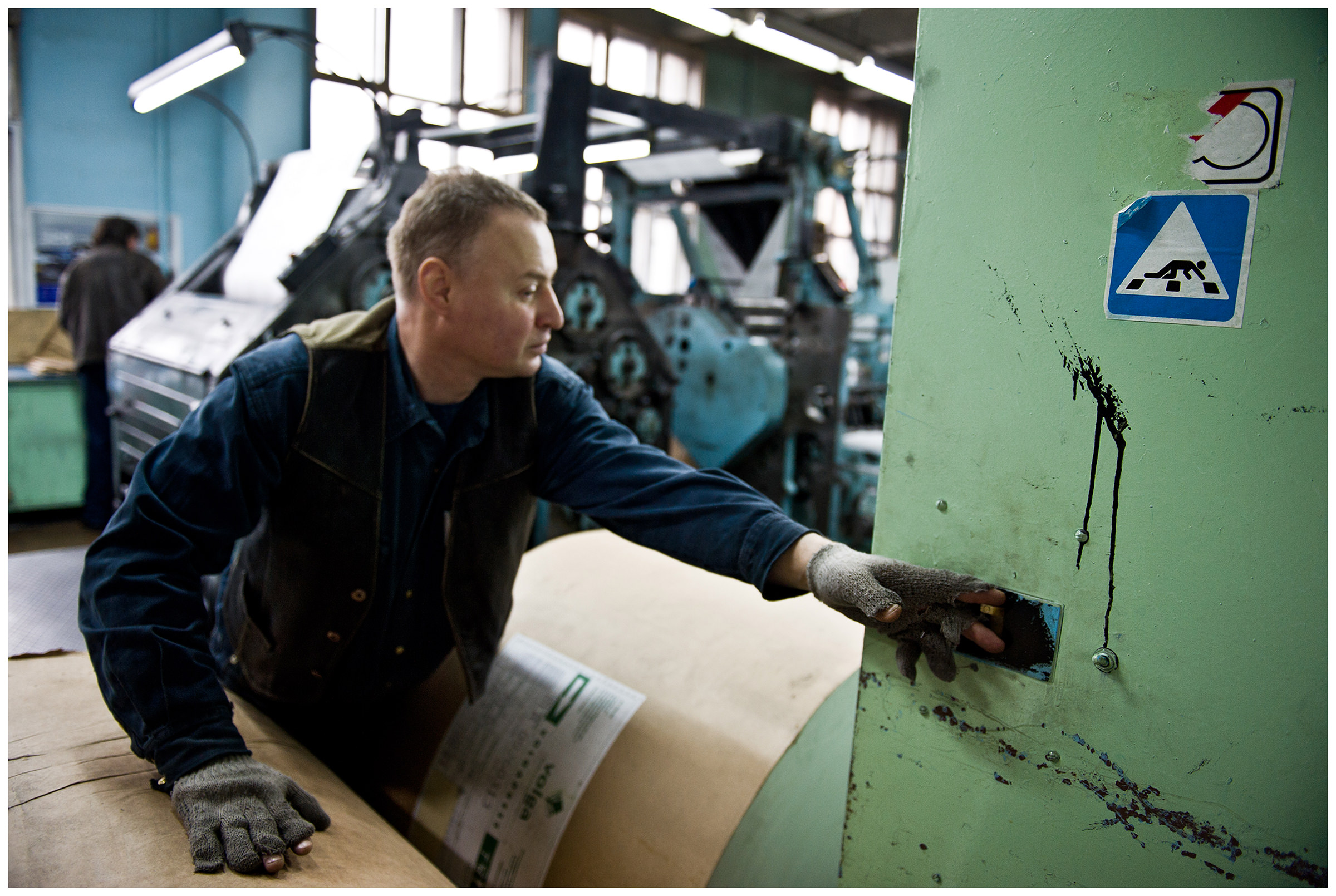Minsk, Belarus, the publishing house "Pechatny Combinat". A printer operates a power switch.