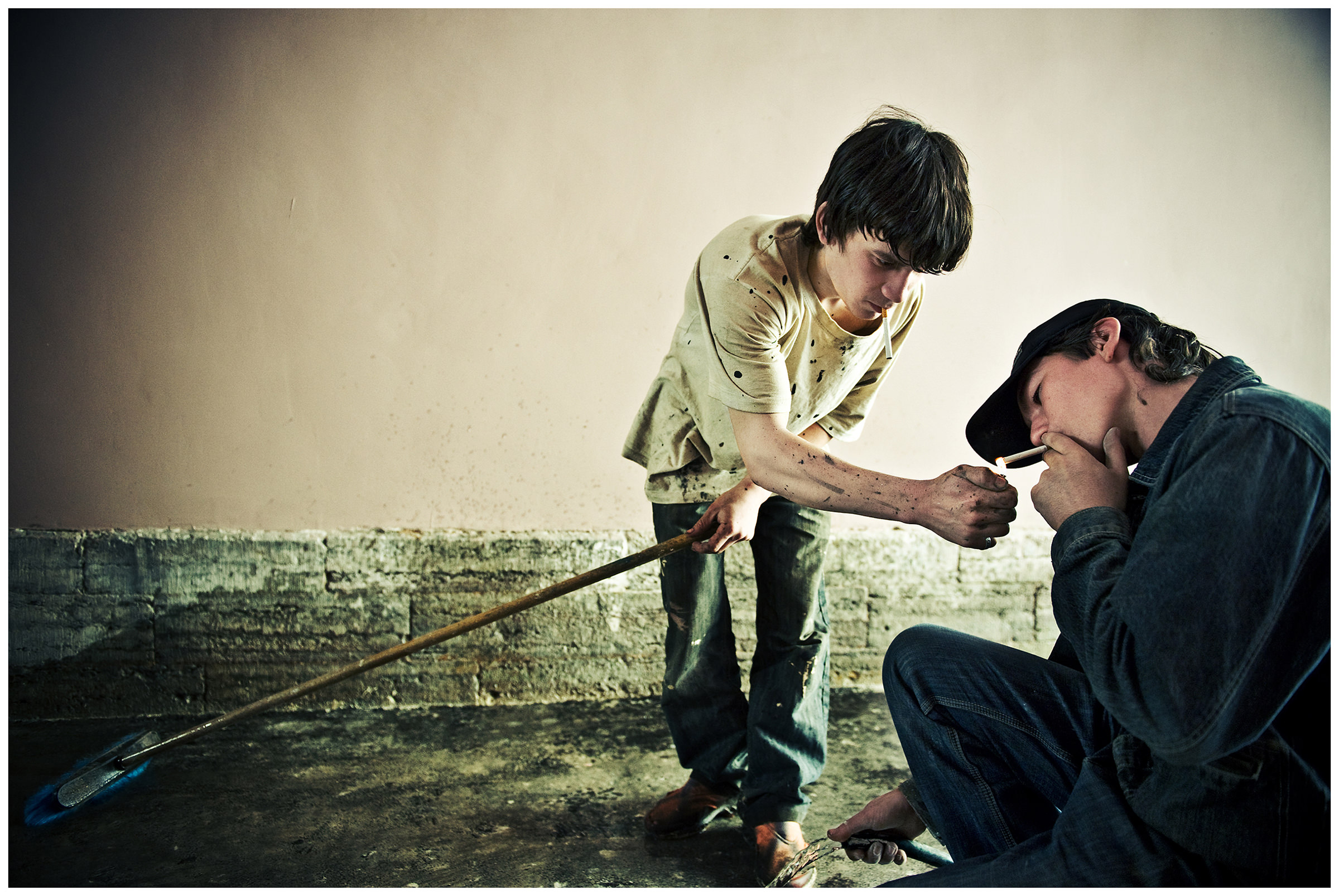 Saint Petersburg, Russia. Two guest workers from Uzbekistan smoking cigarettes at a construction site.