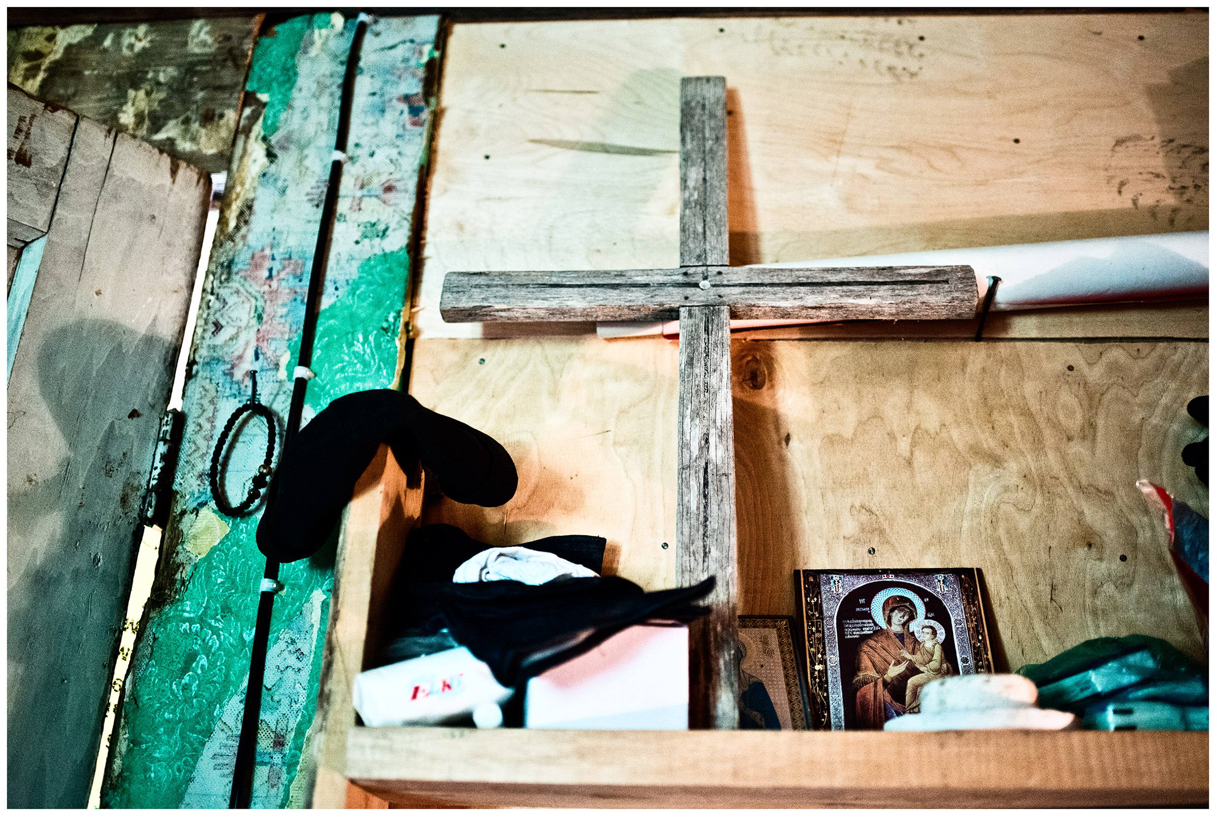 Imereti, Georgia. In the living room of the Georgian monk Maxime Kavtaradze stands a wooden cross from his mother's grave.