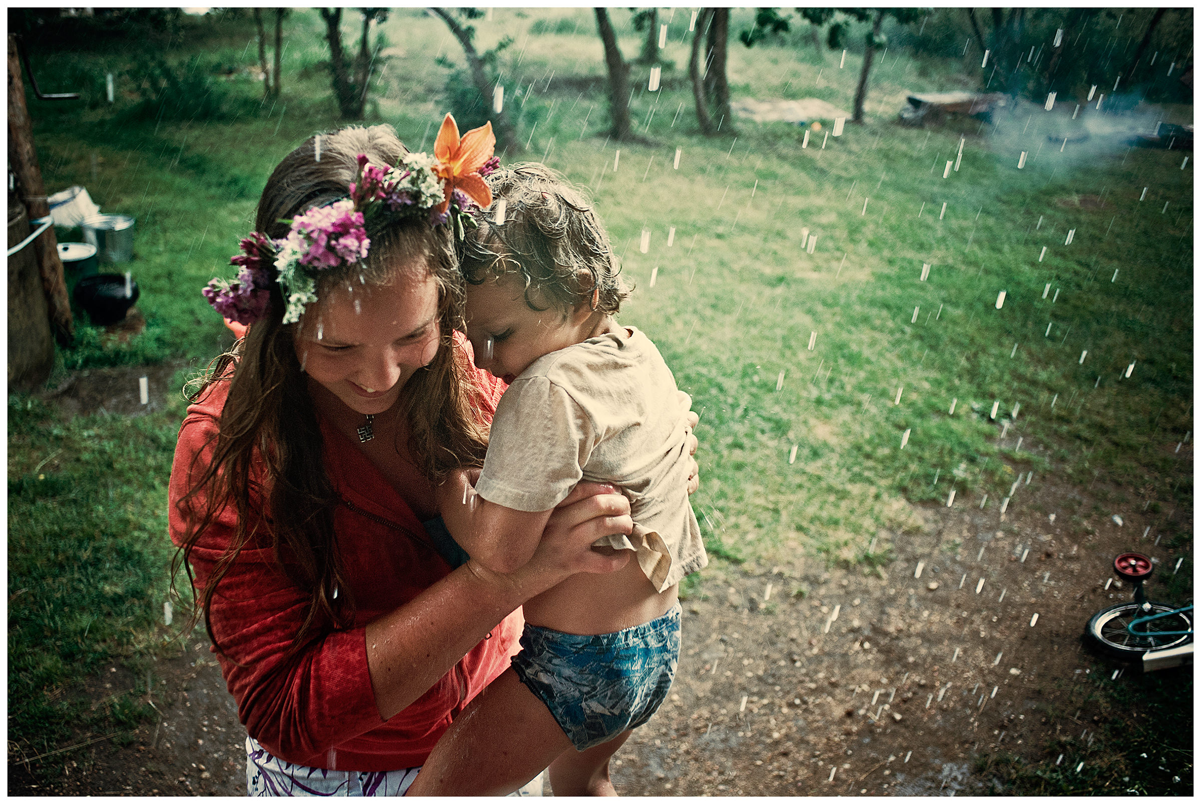 A girl carries a boy home in the rain