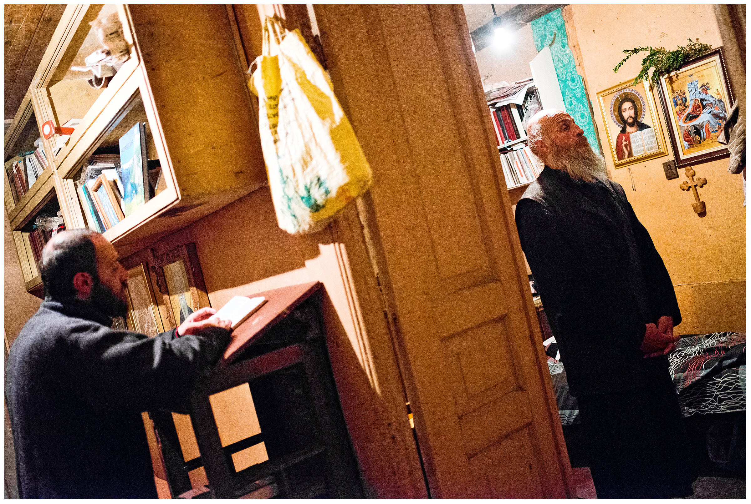 Imereti, Georgia. The Georgian monk Maxime Kavtaradze and his friend are bedding at his home on a rock.