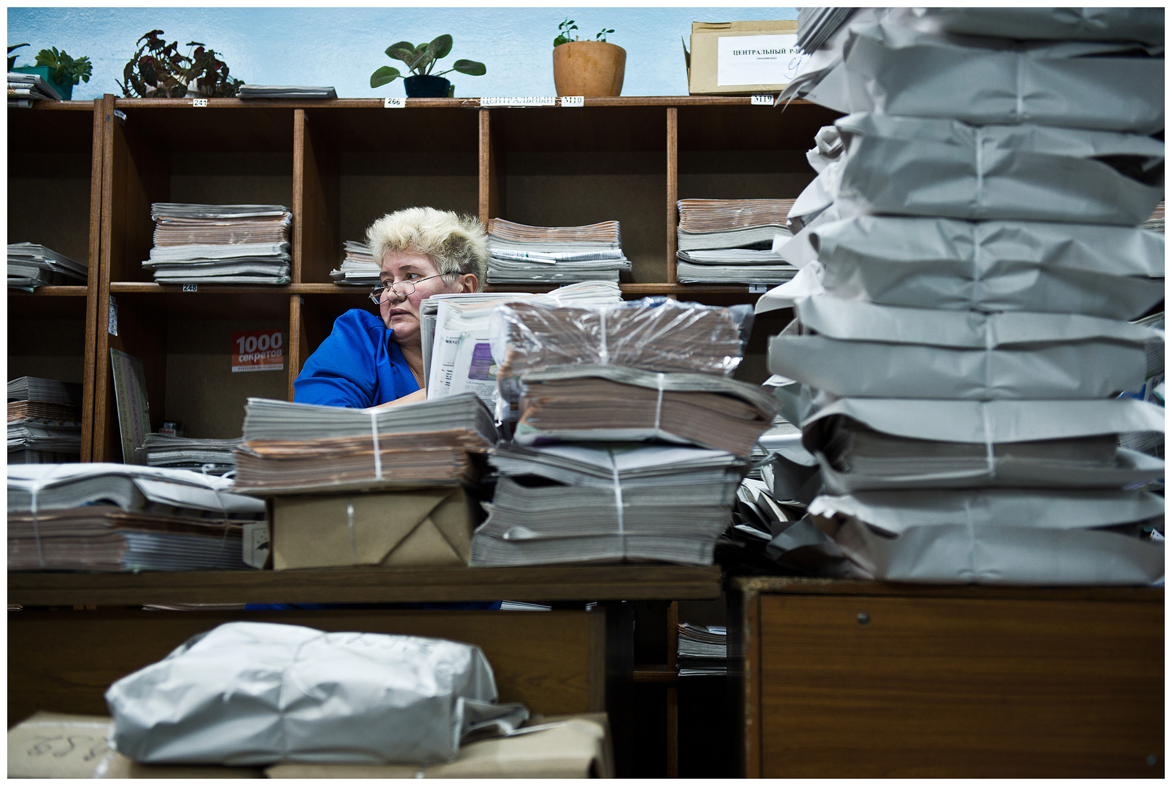 Minsk, Belarus, the publishing house "Pechatny Combinat". A worker sorts packed newspapers.