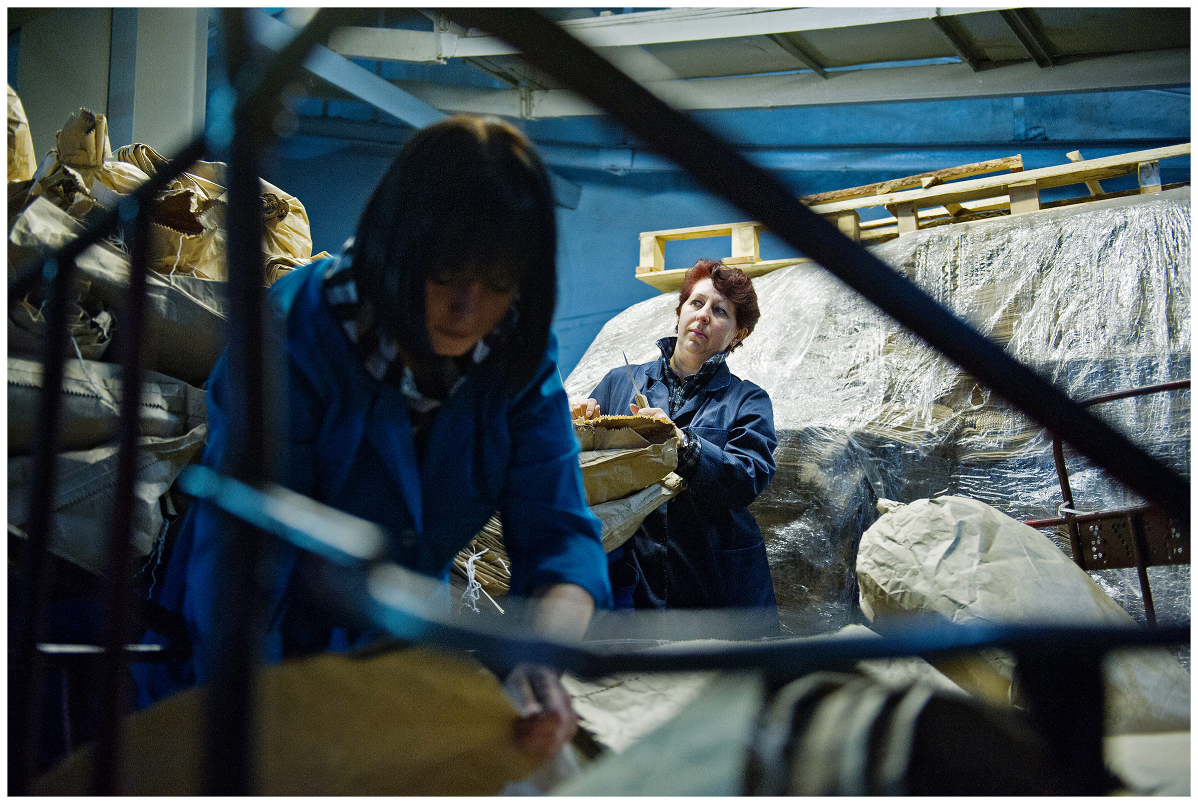 Minsk, Belarus, the publishing house "Pechatny Combinat". Two workers unpack the paper.