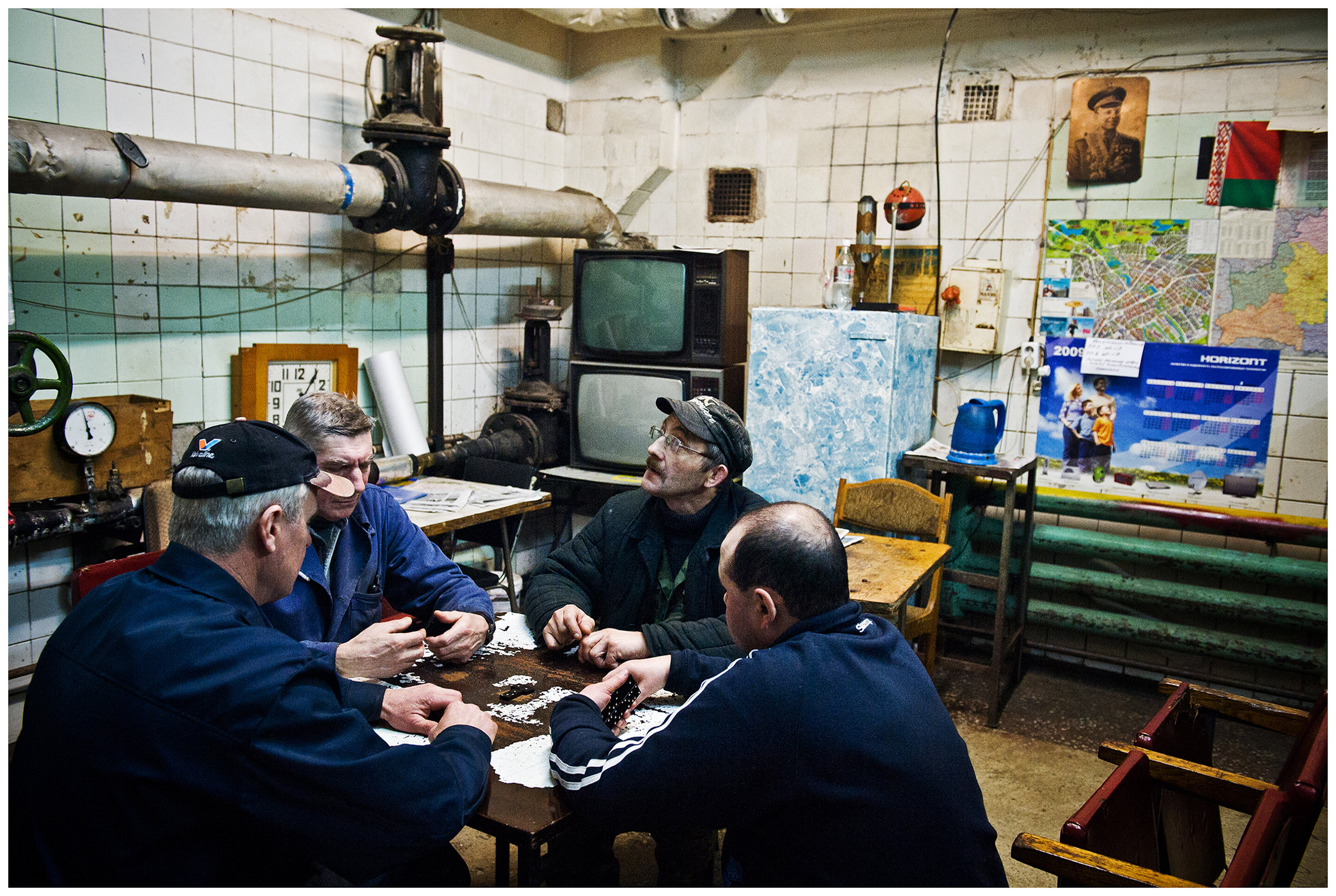 Minsk, Belarus, the publishing house "Pechatny Combinat". The heaters take a break in the bunker under the print shop and play dominoes.