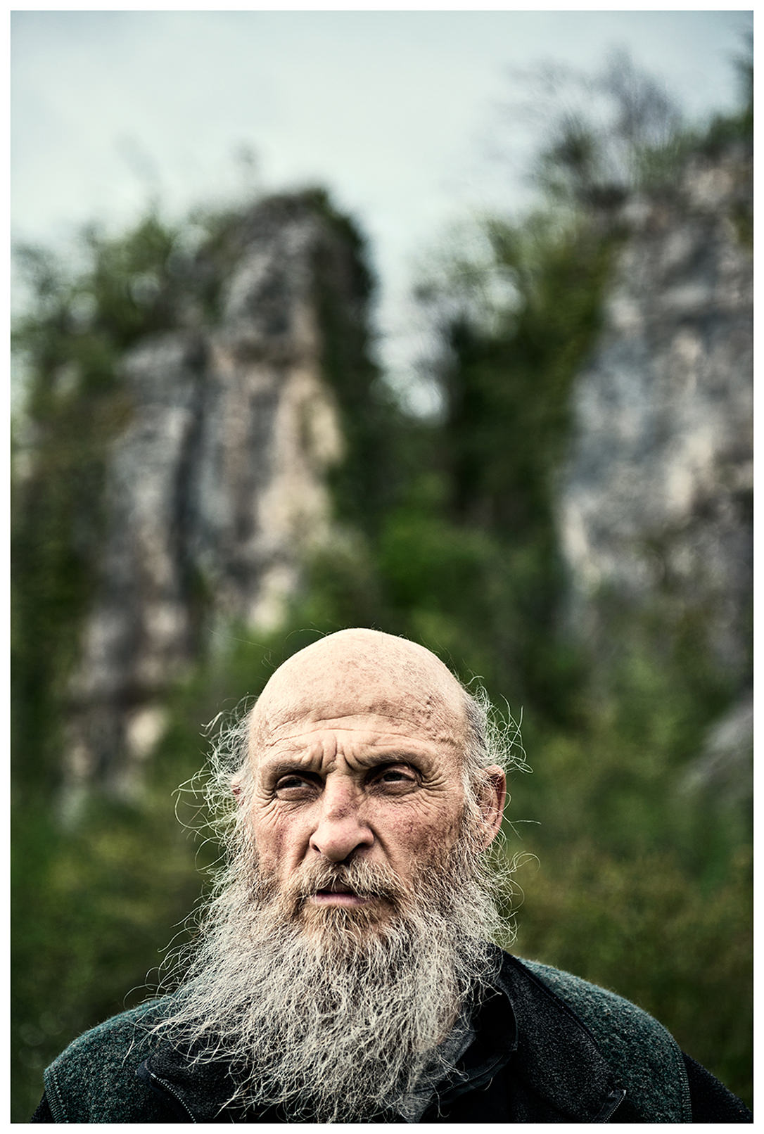 Imereti, Georgia. The Georgian monk Maxime Kavtaradze stands in front of a rock.