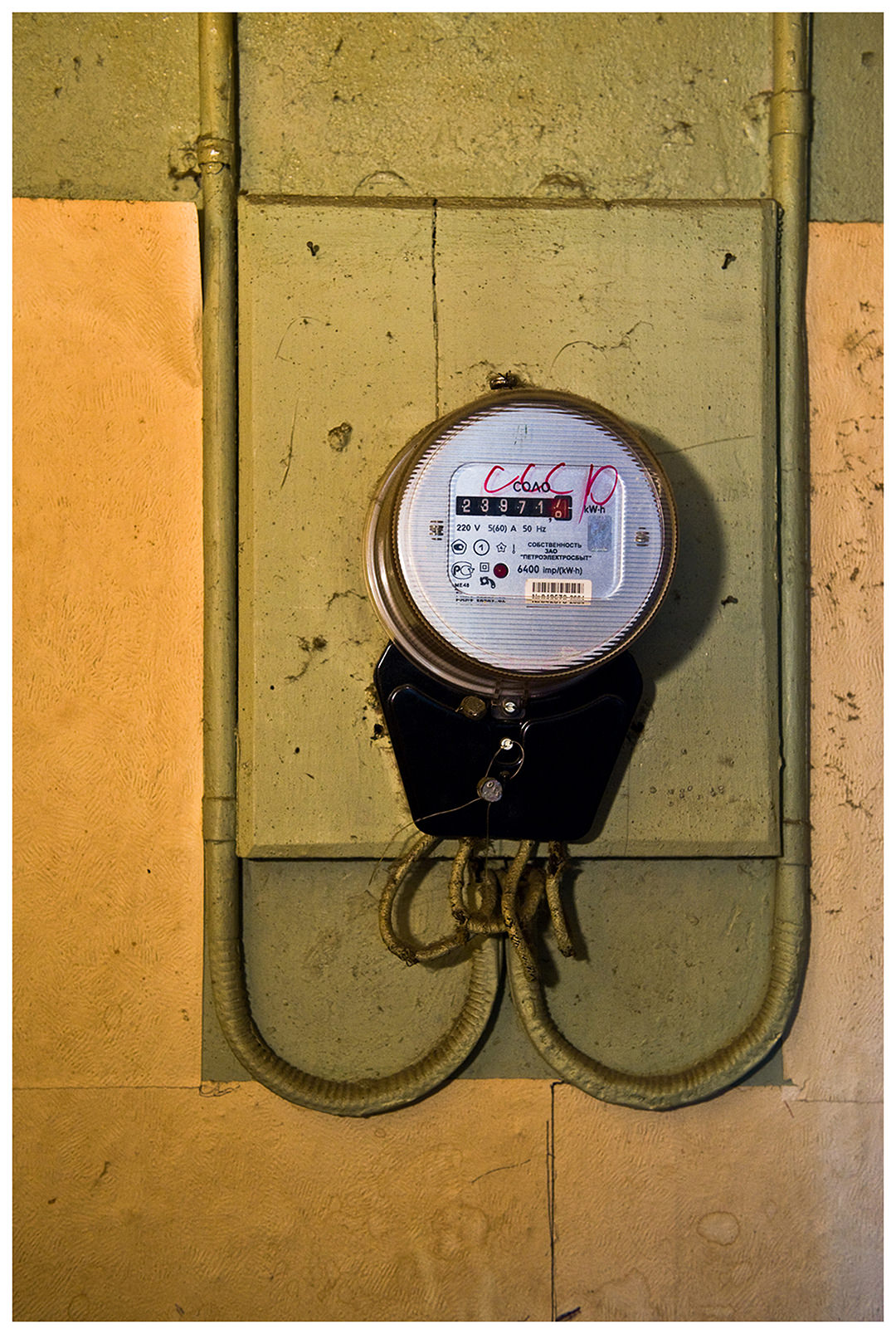 Saint Petersburg, Russia. An electricity meter with the handwritten stroke USSR hangs in the corridor of the apartment rented by the guest workers.