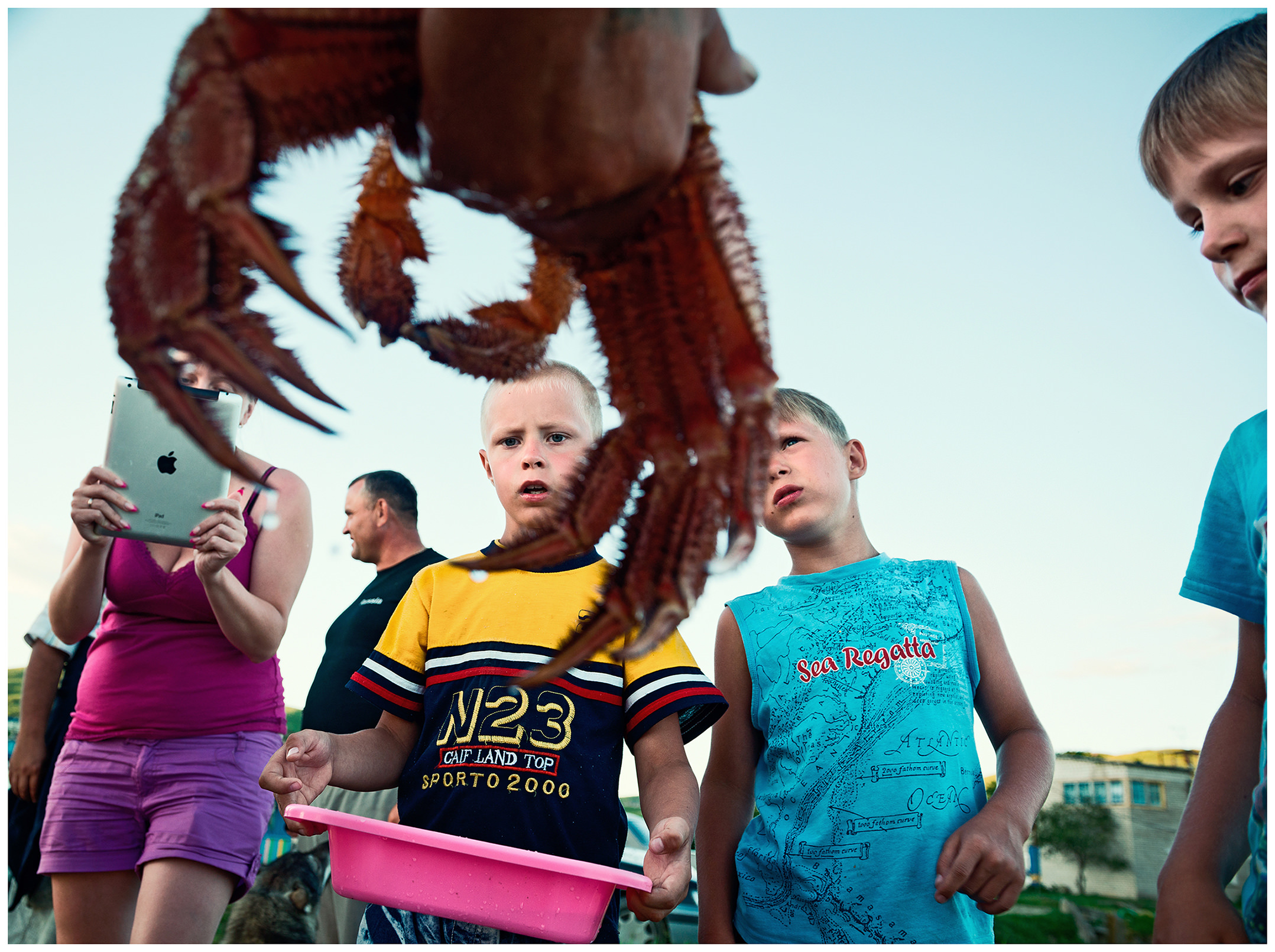 Village Posyet, Primorye, Russia. Every time the poachers come ashore with their prey, it is a welcome attraction for tourists and their children. A part of the catch will be sold to them immediately.