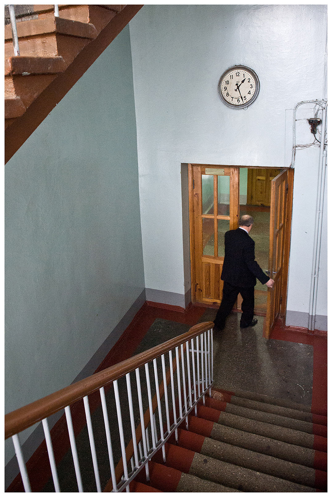 Minsk, Belarus, the publishing house "Pechatny Combinat". An employee opens the door in a staircase.