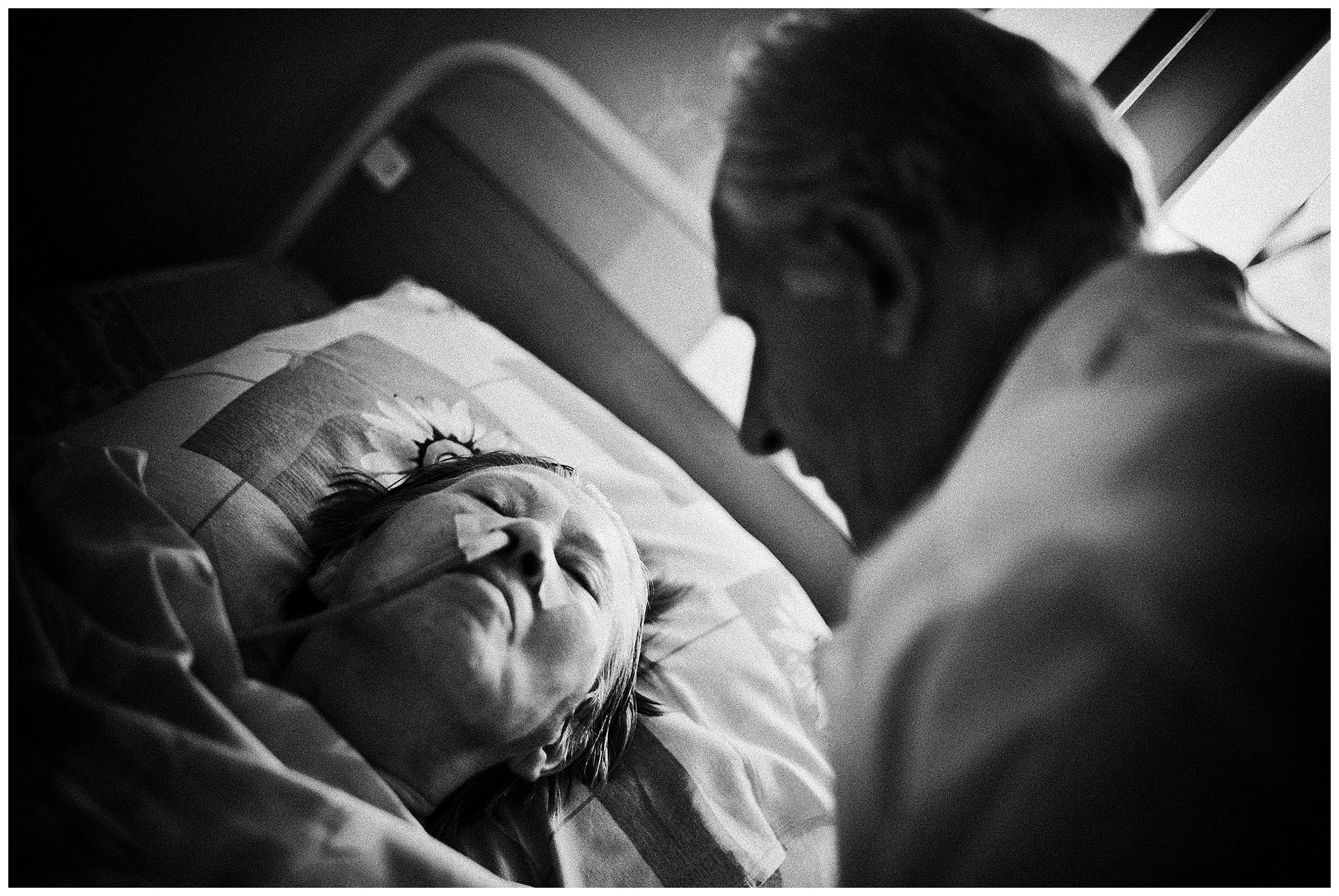 Minsk Hospice, Minsk, Belarus. An old man is sitting at his wife's bed, who he has just brought to the hospice.
