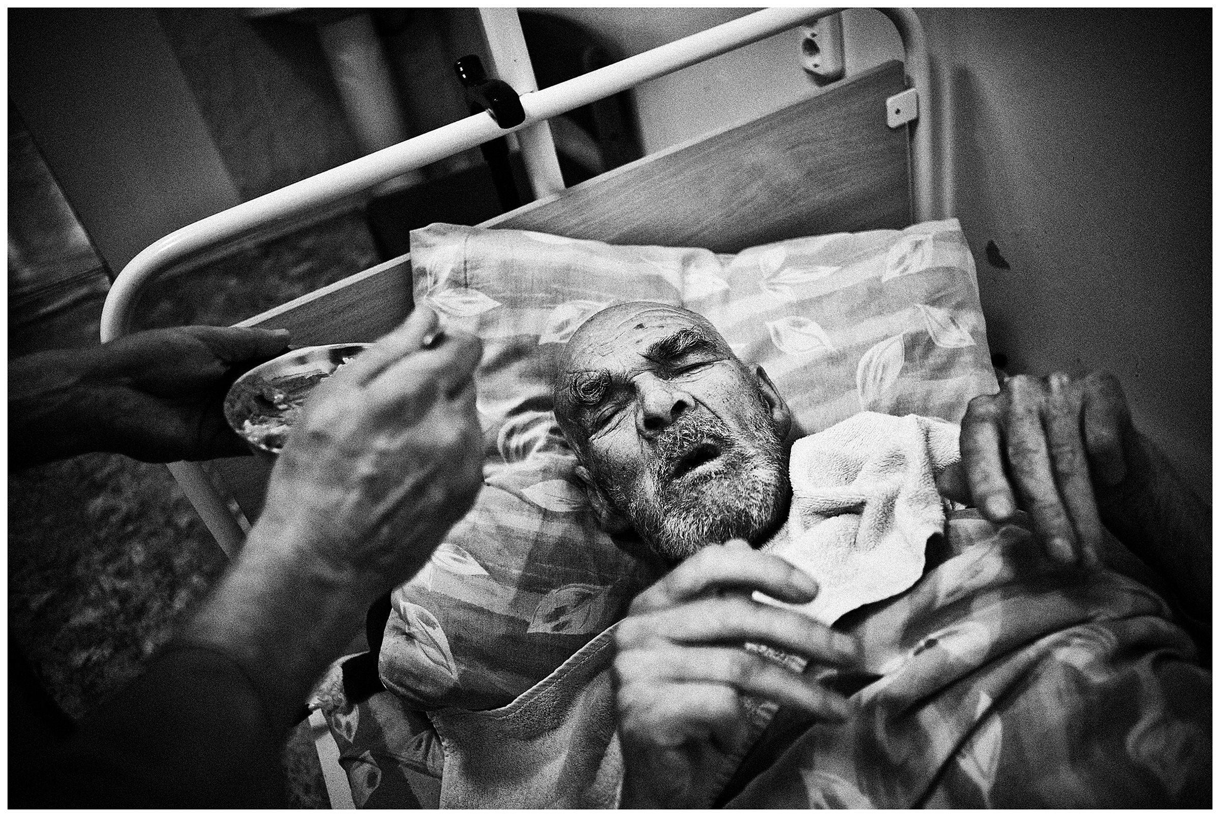 Minsk Hospice, Minsk, Belarus. A patient is fed by a nurse.