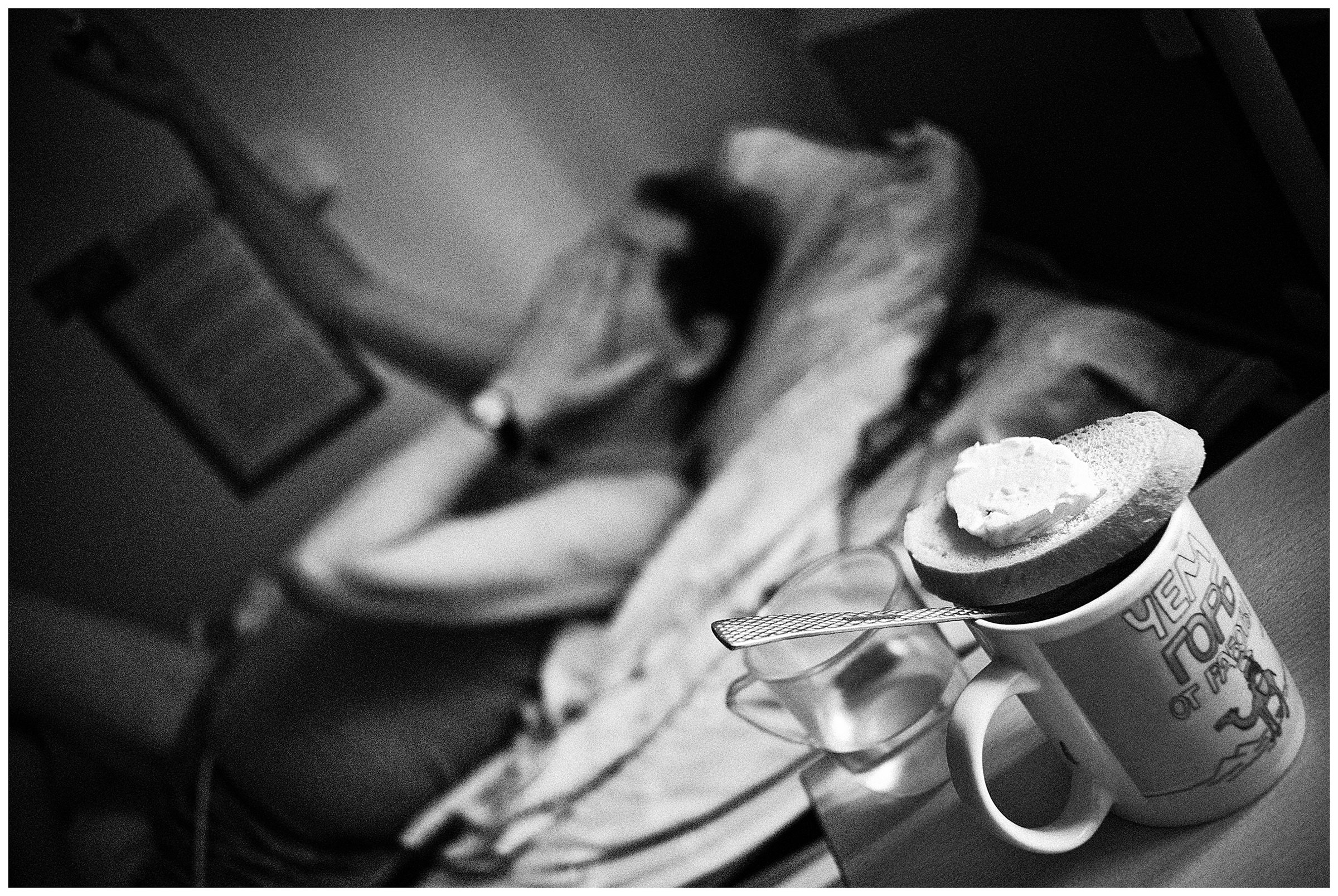 Minsk Hospice, Minsk, Belarus. A slice of bread with a piece of butter lies on a cup.