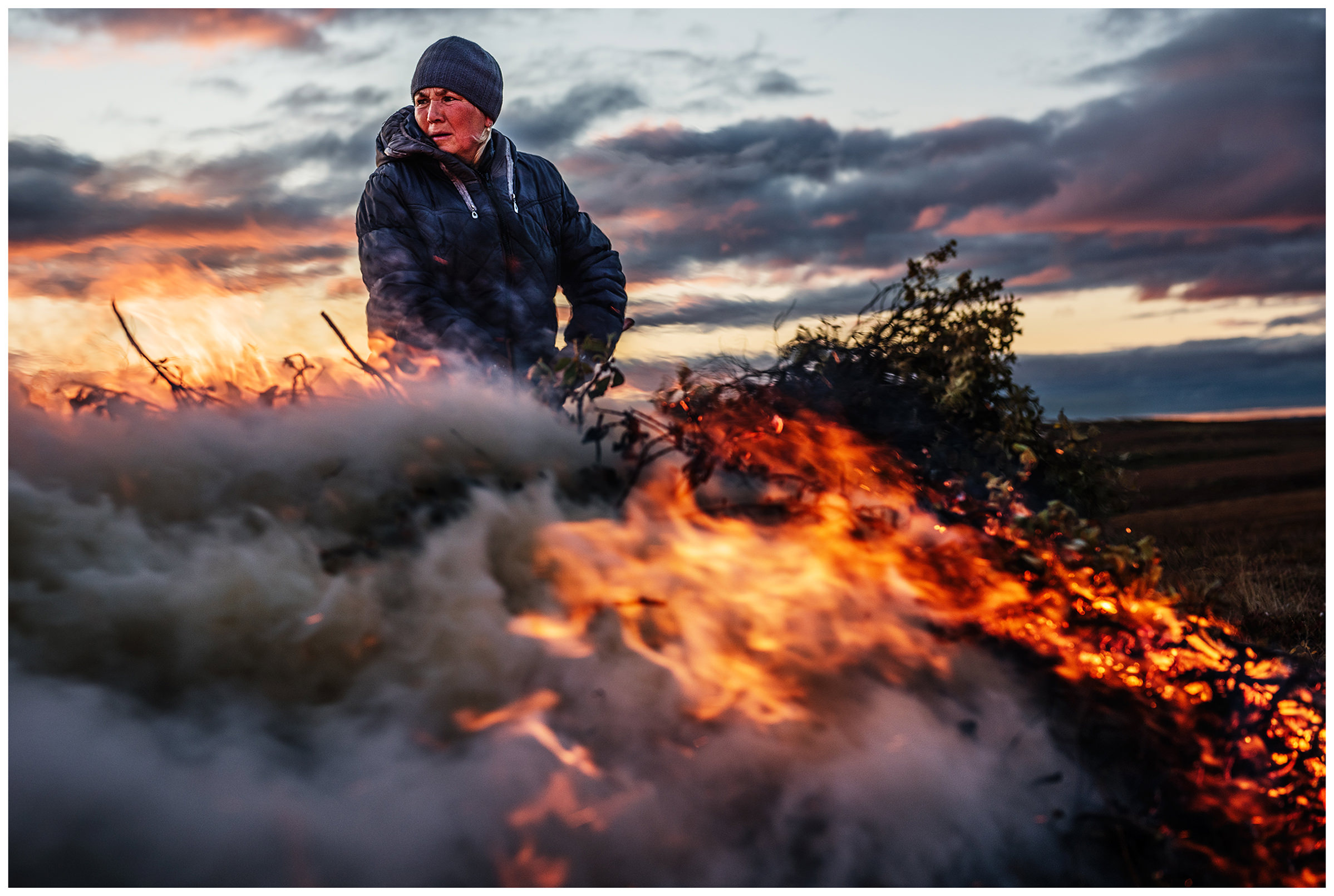 Nenets Autonomous Okrug, Komi Republic, Russia. A woman burns garbage.