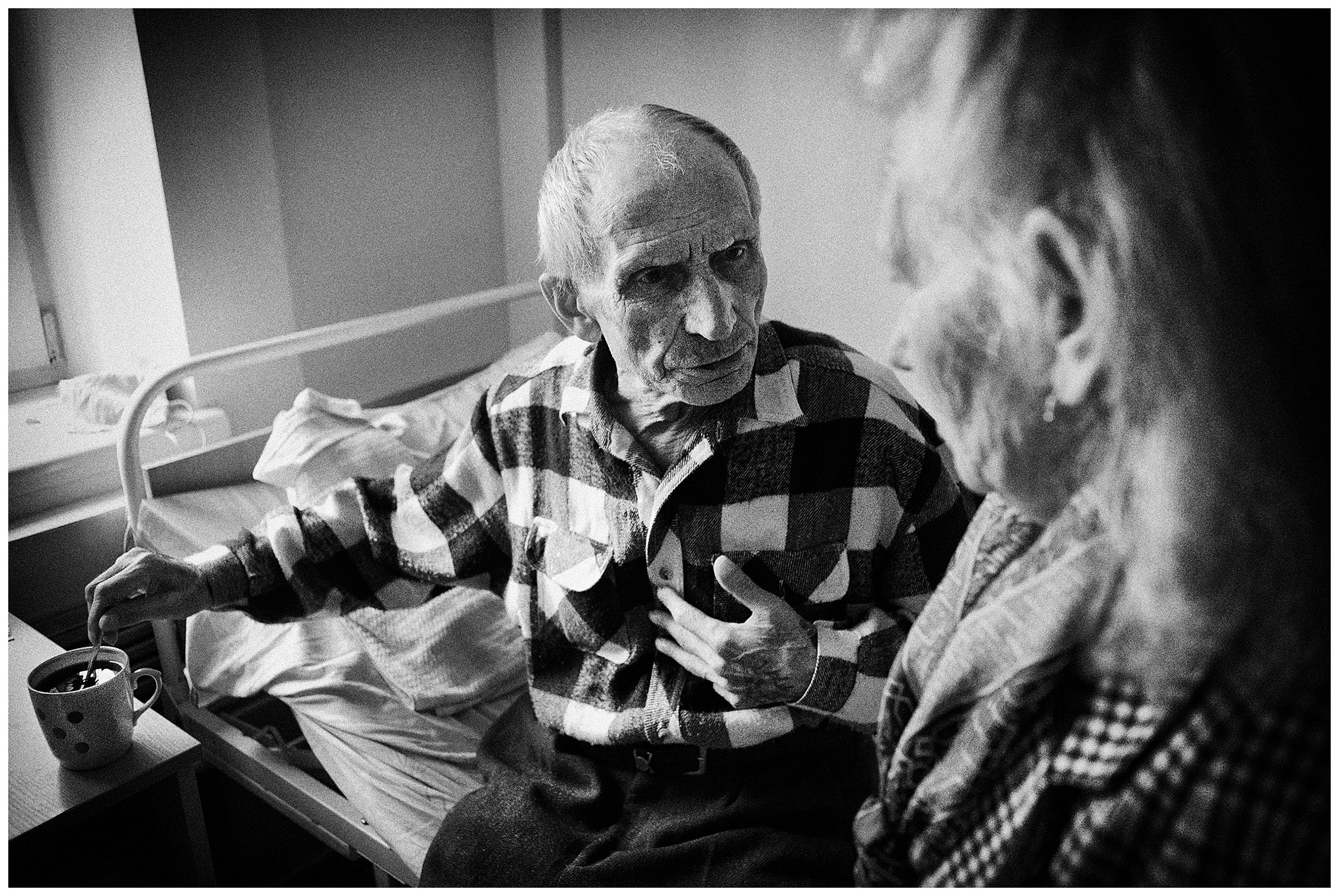 Minsk Hospice, Minsk, Belarus. A patient talks to his wife, who comes to visit him.