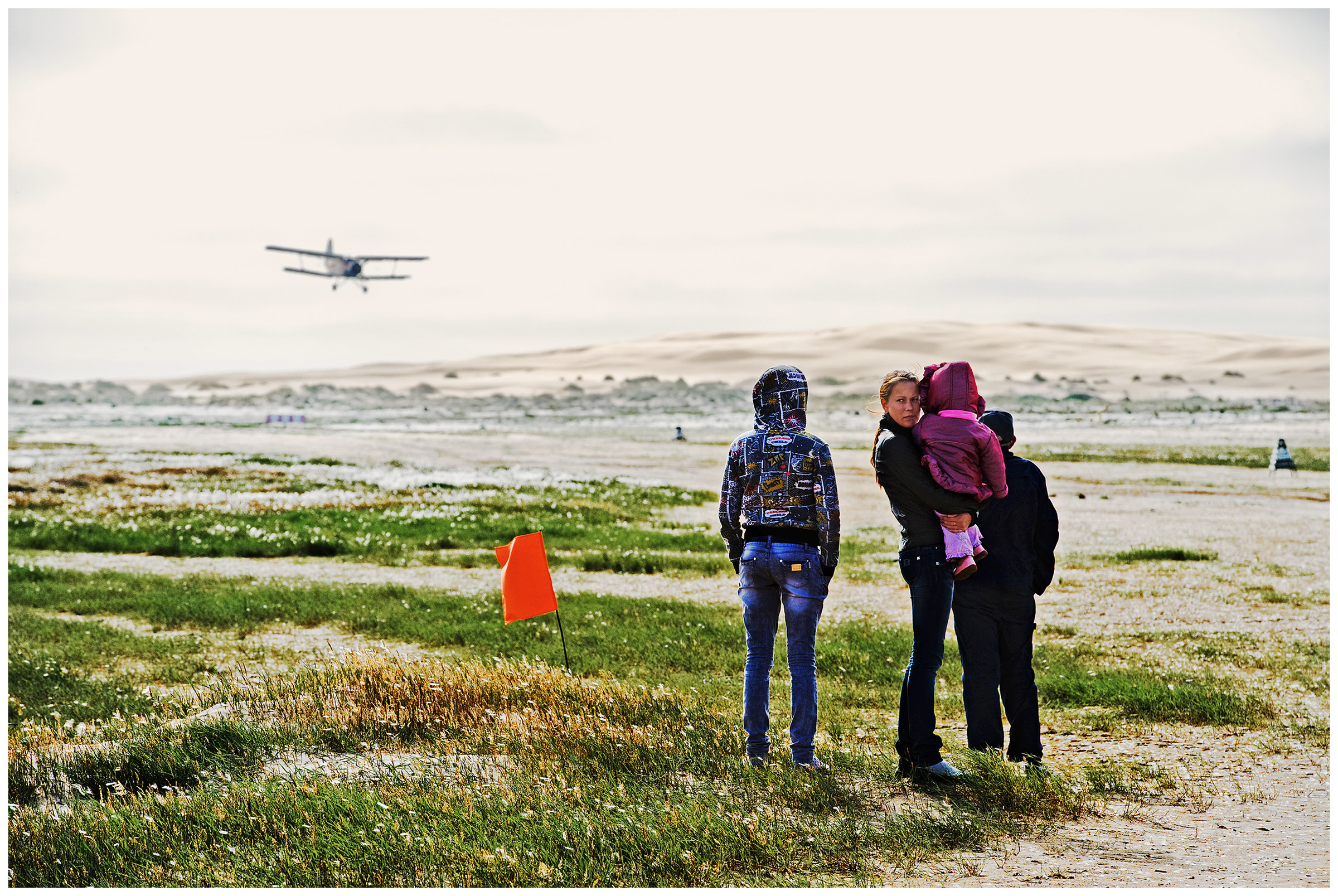 Shoyna village, Russia. Young people waiting for the arrival of a plane.