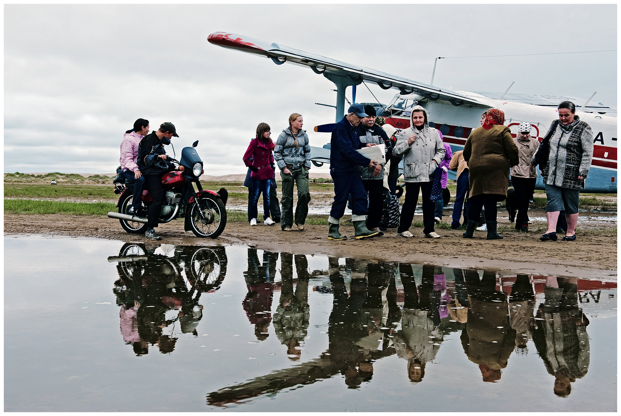 Shoyna village, Russia. People meet passengers on a plane that has just landed.
