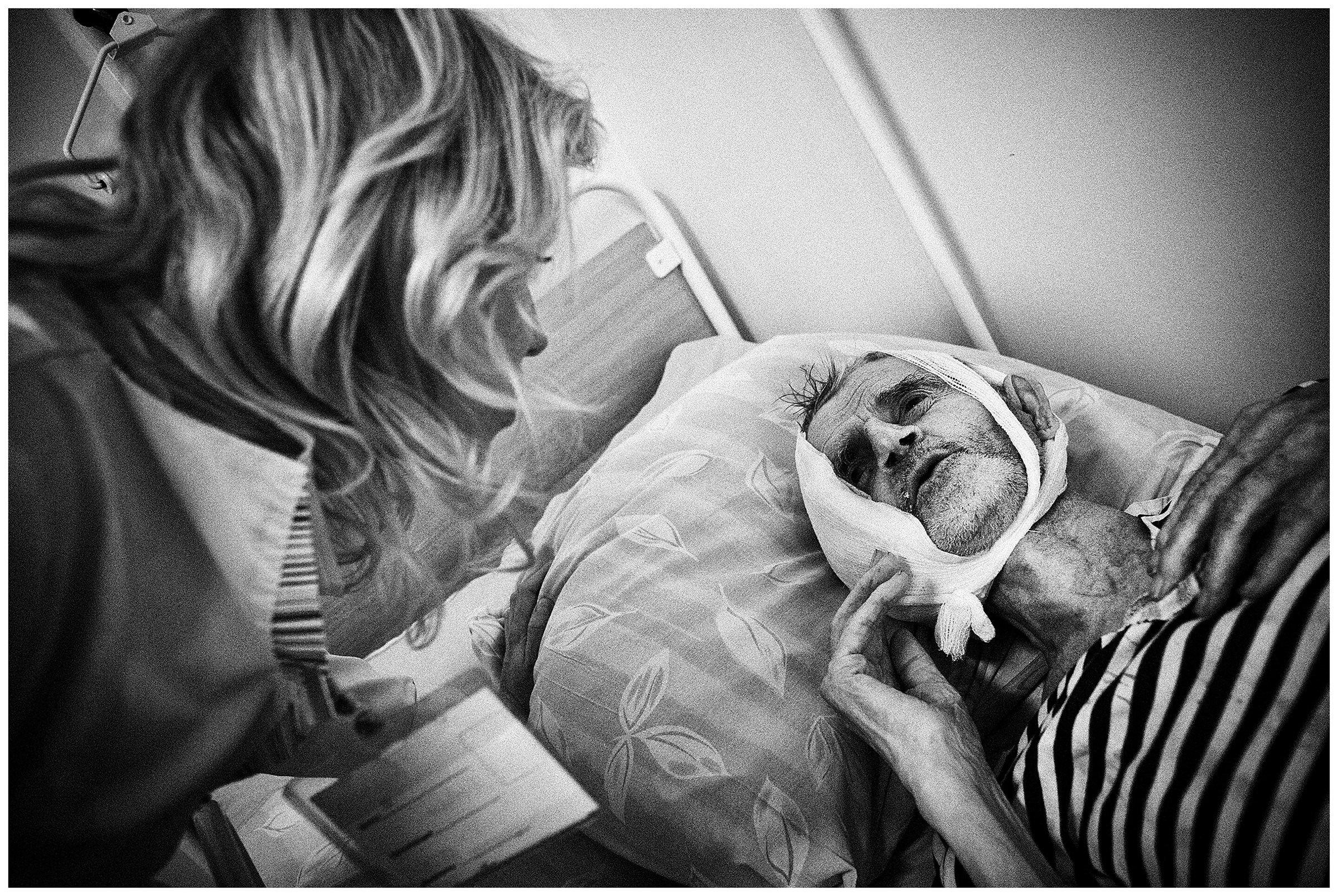 Minsk Hospice, Minsk, Belarus. A nurse talks to her patient.