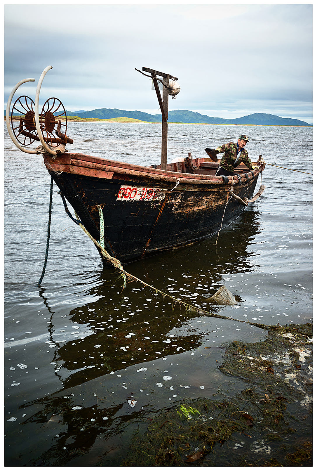 Primorye, Russia An inspector dismantles a North Korean boat to use as firewood.