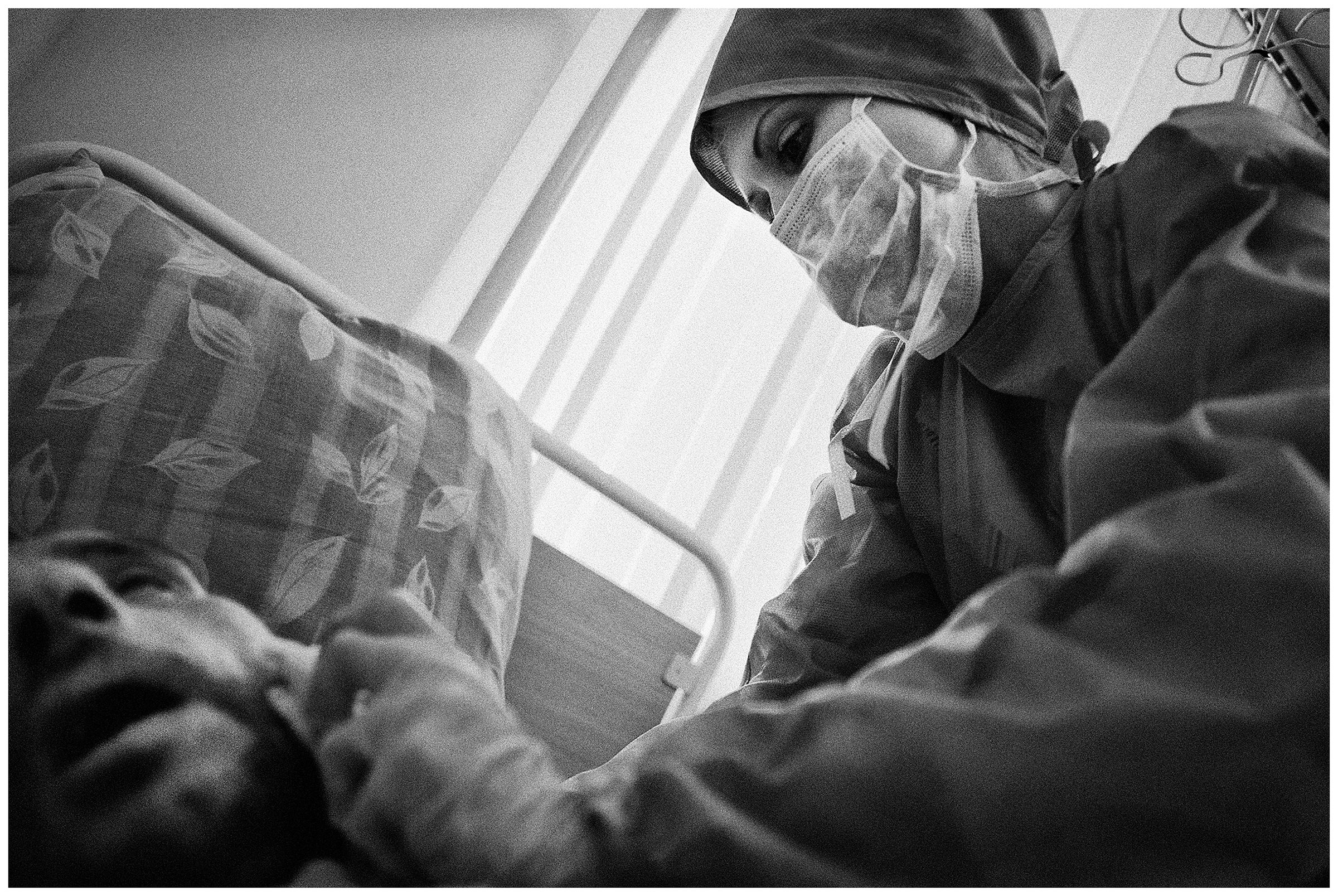 Minsk Hospice, Minsk, Belarus. A nurse takes care of her patient.