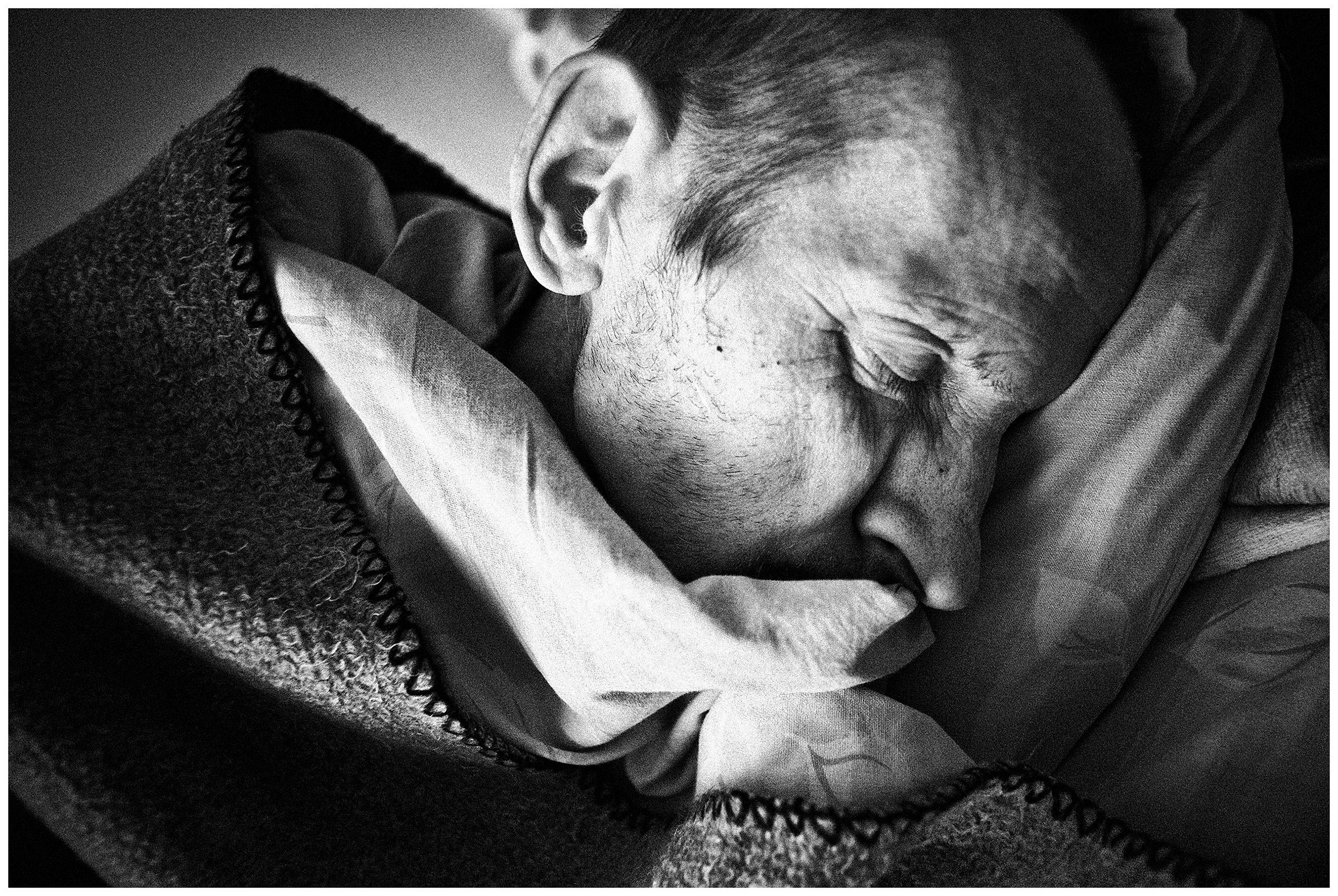 Minsk Hospice, Minsk, Belarus. A patient sleeps after lunch.