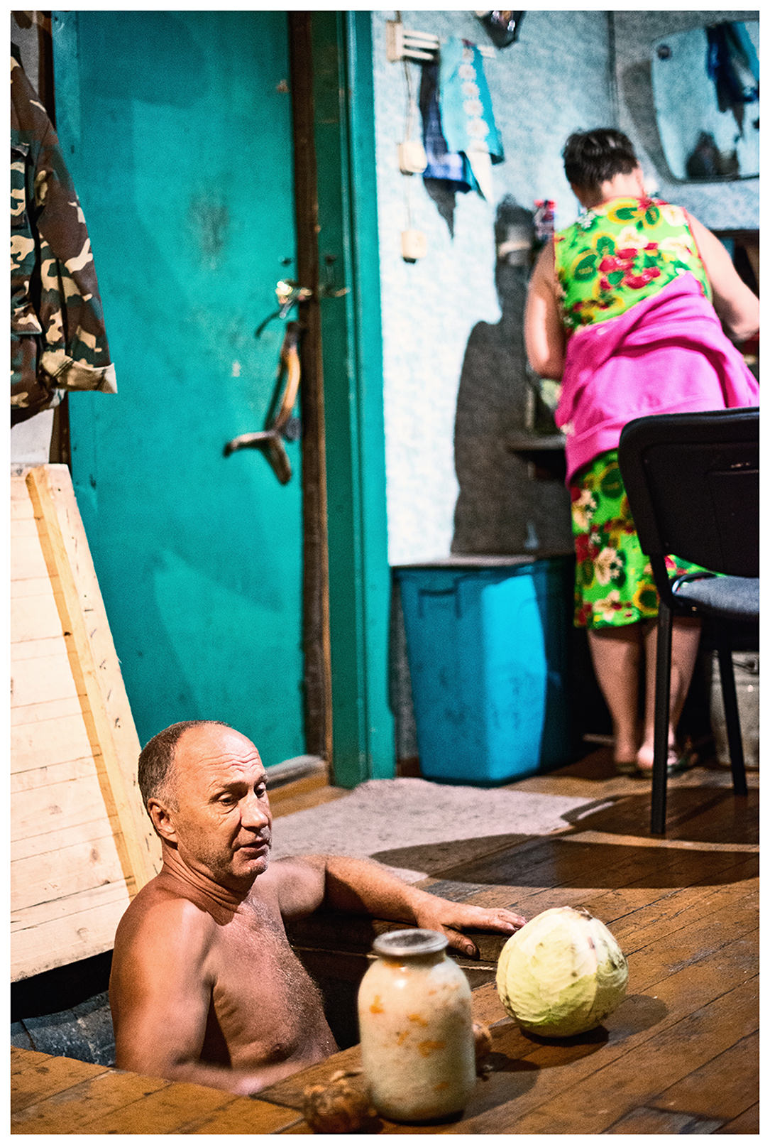 Bay Pemzovaya, Primorye, Russia. A border guard fetches sauerkraut and vegetables from the cellar.